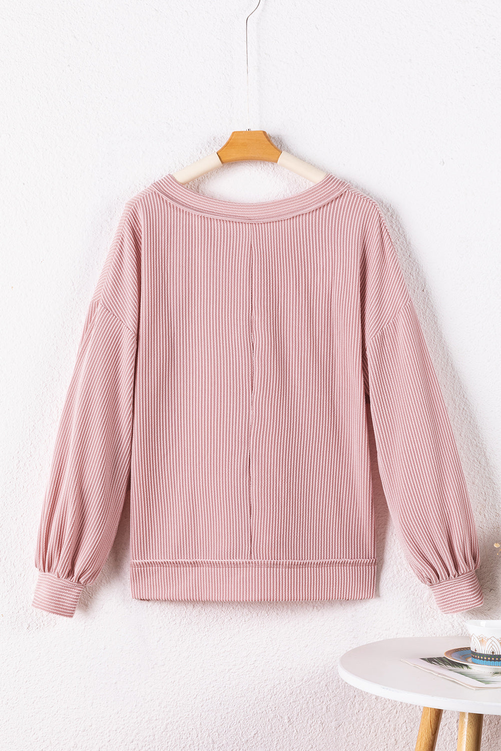Peach Blossom Loose V Neck Bubble Sleeve Knit Ribbed Top showcasing a feminine silhouette with bubble sleeves and a soft ribbed texture.