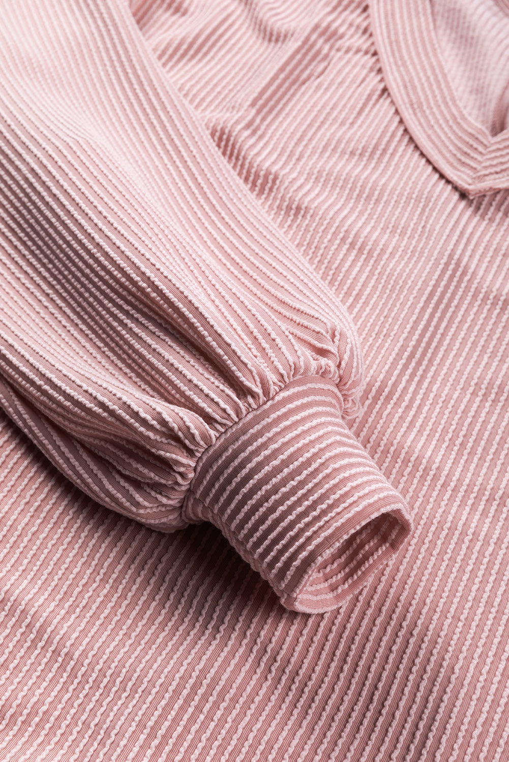 Peach Blossom Loose V Neck Bubble Sleeve Knit Ribbed Top showcasing a feminine silhouette with bubble sleeves and a soft ribbed texture.