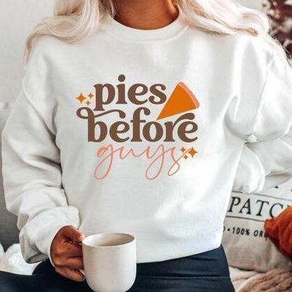 A cozy unisex pullover featuring the phrase 'Pies Before Guys', made from a soft cotton/poly blend, perfect for casual wear.