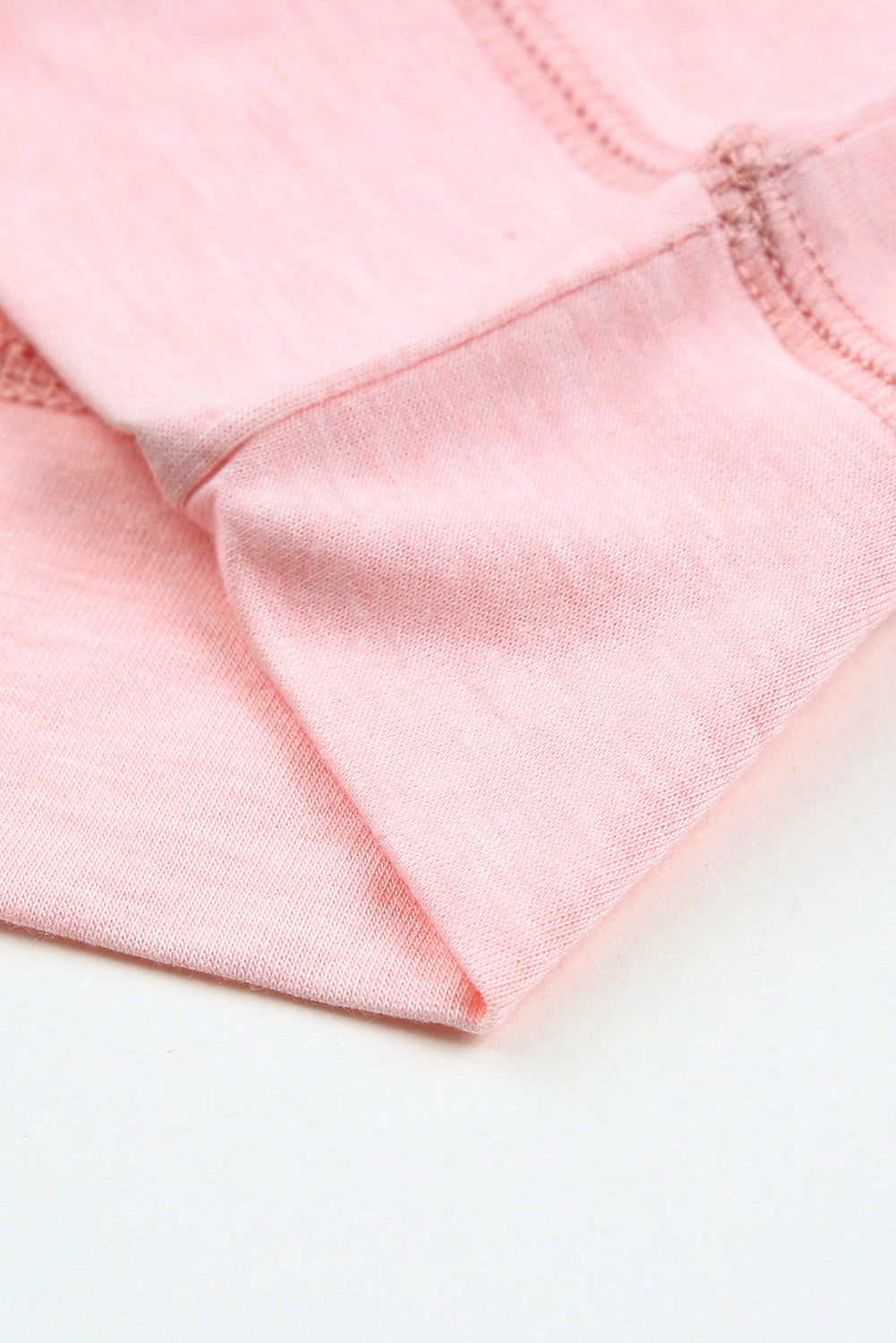 A stylish pink crewneck t-shirt featuring raglan sleeves with striped patchwork design, perfect for summer wear.
