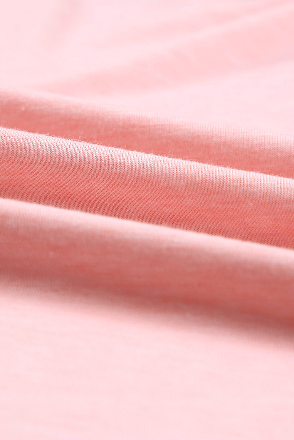 A stylish pink crewneck t-shirt featuring raglan sleeves with striped patchwork design, perfect for summer wear.