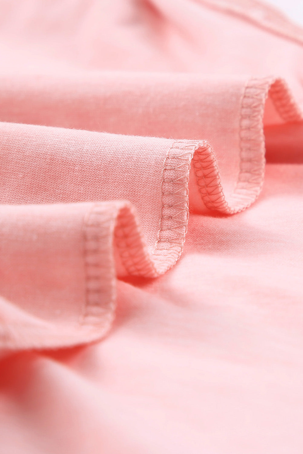 A stylish pink crewneck t-shirt featuring raglan sleeves with striped patchwork design, perfect for summer wear.