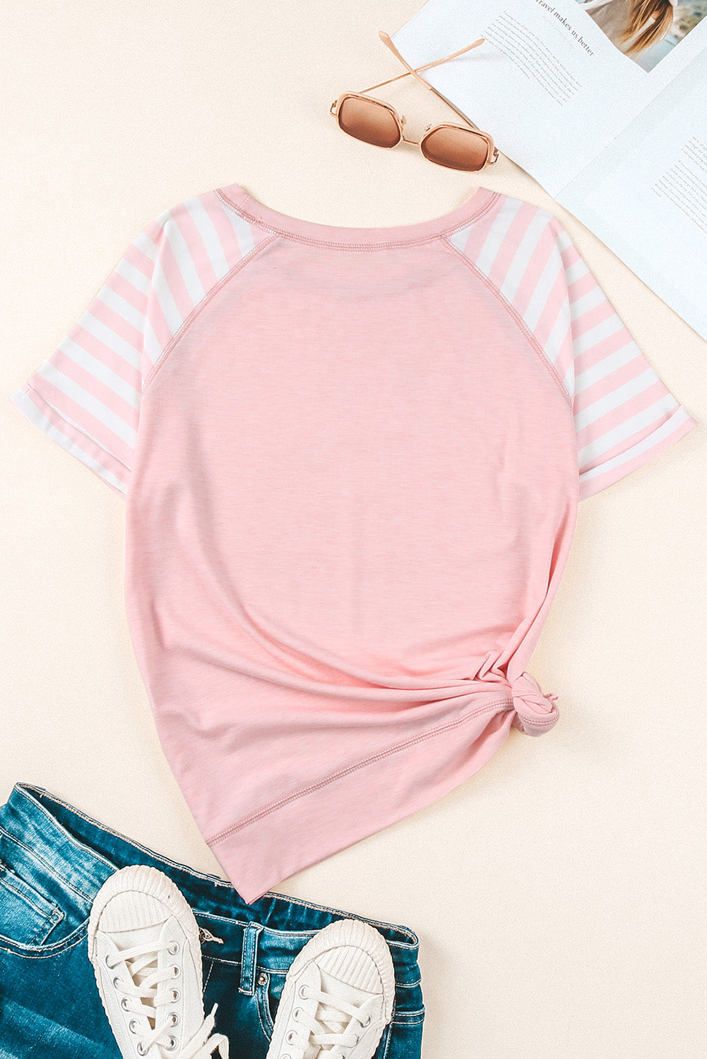 A stylish pink crewneck t-shirt featuring raglan sleeves with striped patchwork design, perfect for summer wear.