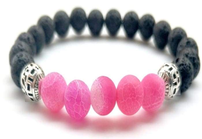 A stylish pink lava stone bracelet designed for essential oil diffusion, showcasing its porous texture and elegant appearance.