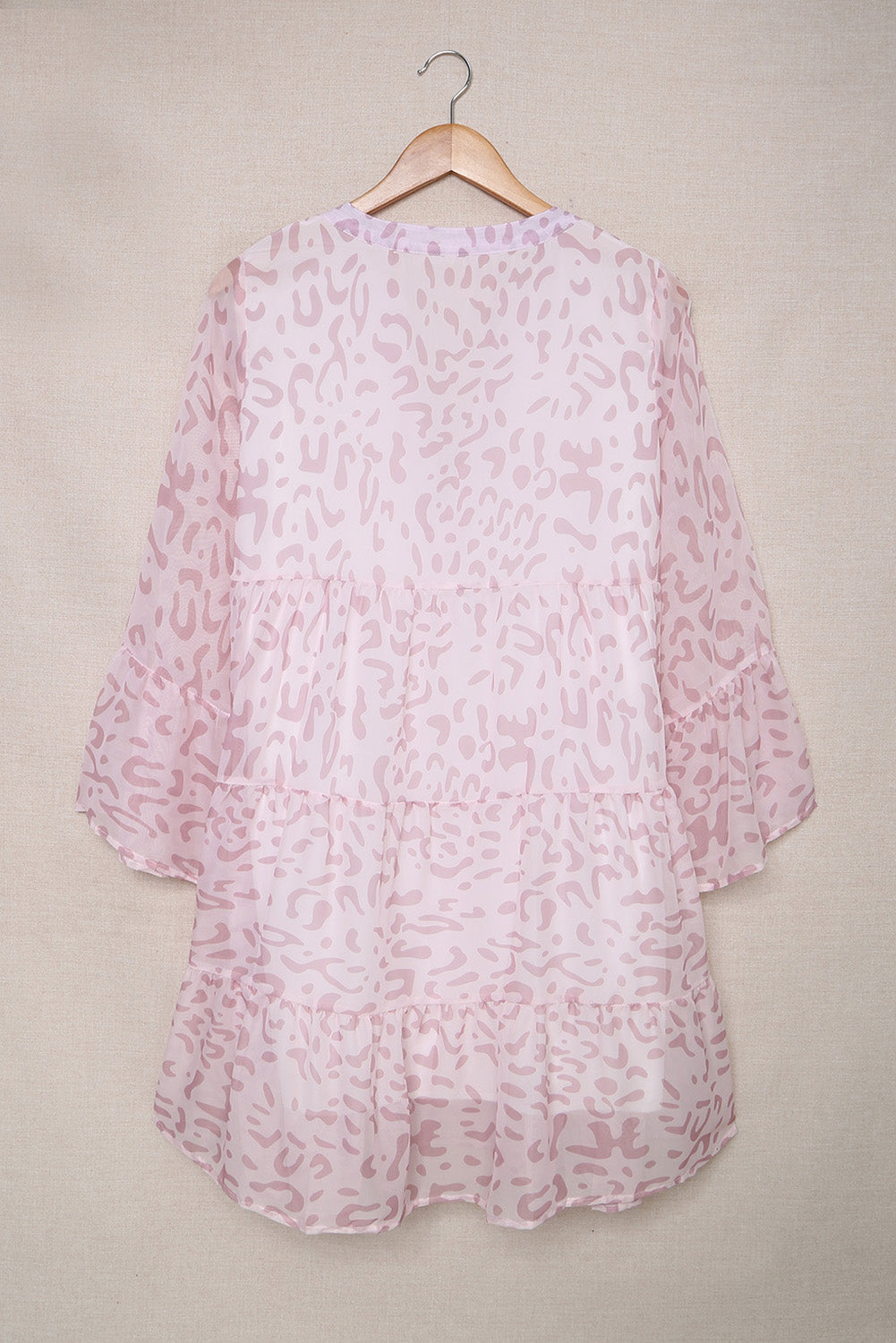 A stylish Pink Leopard Print V Neck Ruffle Swing Mini Dress featuring a deep V neckline and ruffle details, perfect for casual and formal occasions.