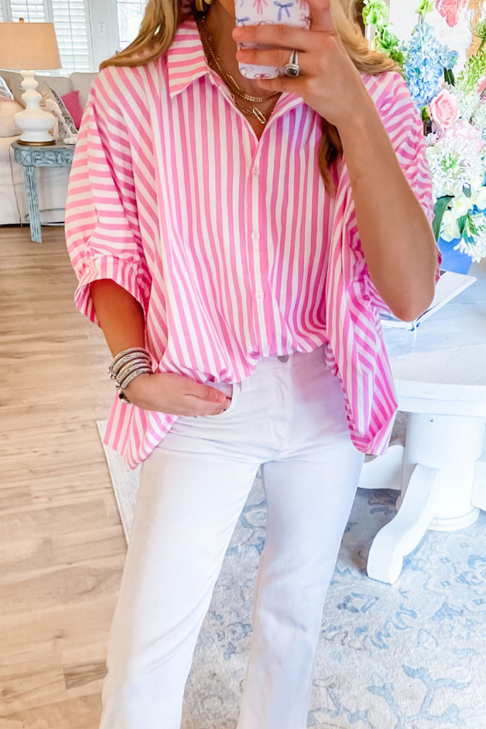 A stylish pink stripe dolman sleeve oversize shirt displayed on a mannequin, showcasing its relaxed fit and trendy design.