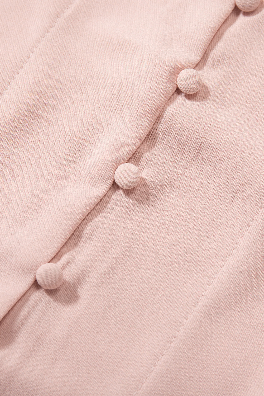 A stylish pink blouse featuring a V neck, lace splicing cuffs, and a button knotted design, perfect for casual and formal wear.