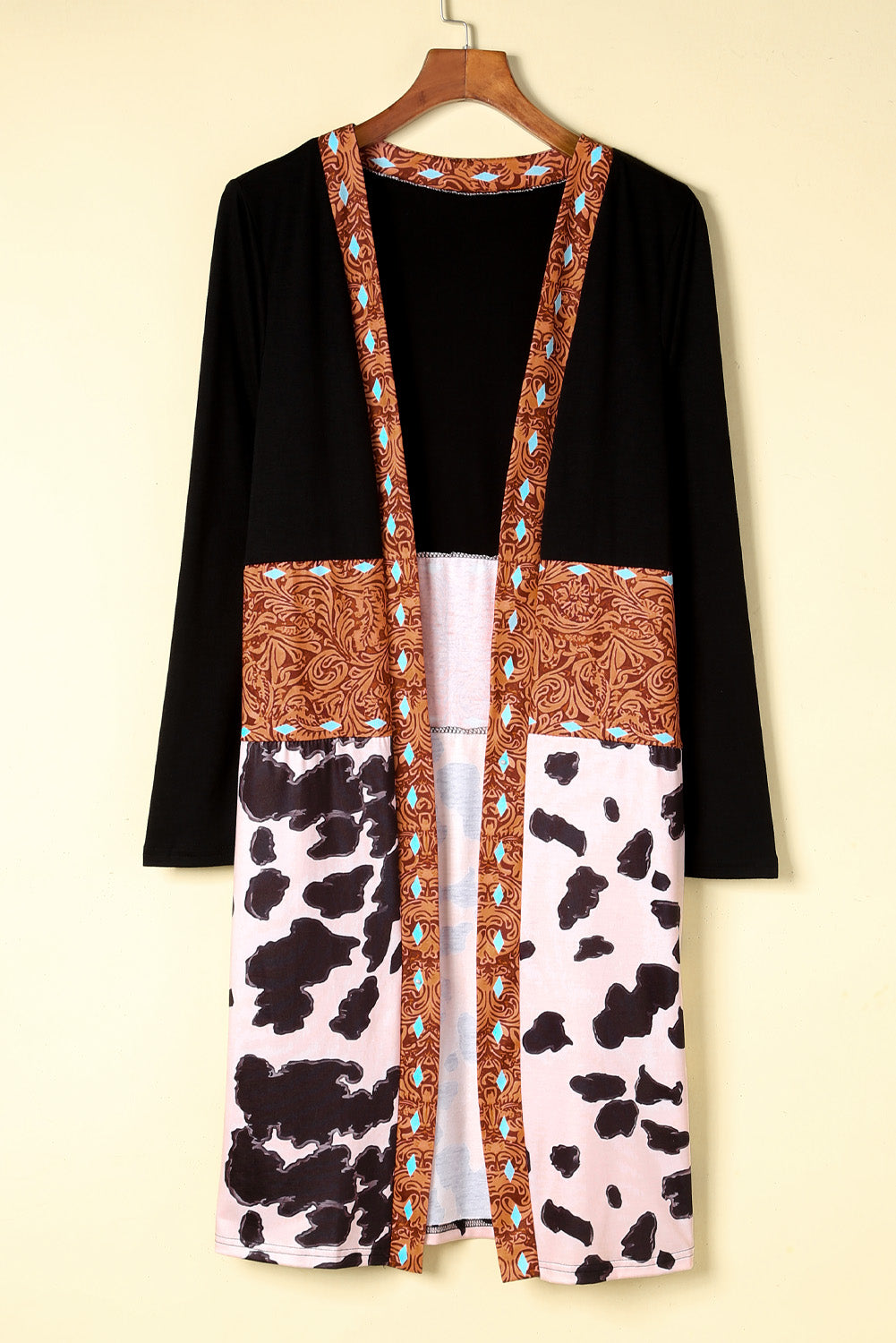 A stylish pink cardigan featuring a western cow patchwork design, open front style, perfect for casual wear.