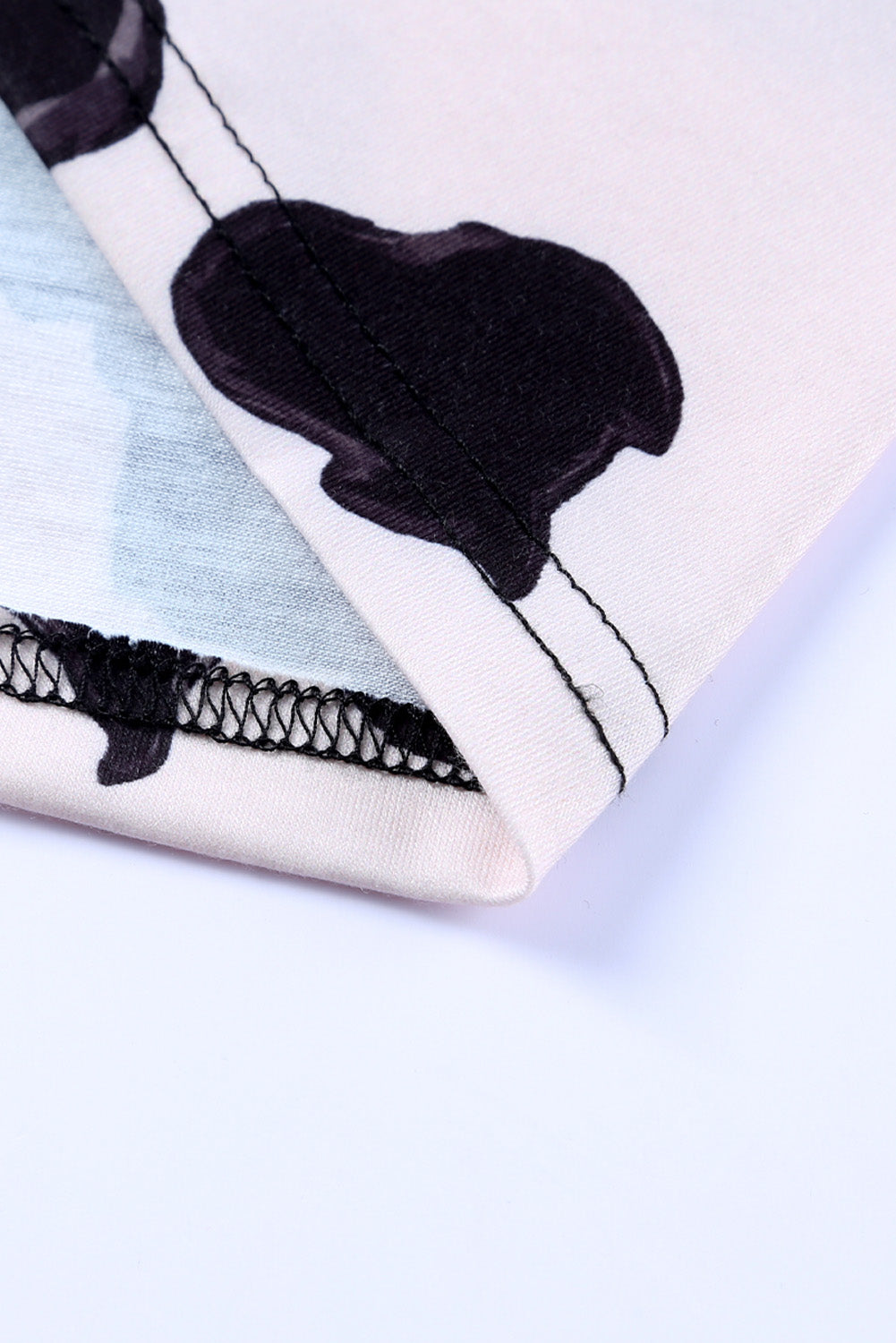 A stylish pink cardigan featuring a western cow patchwork design, open front style, perfect for casual wear.