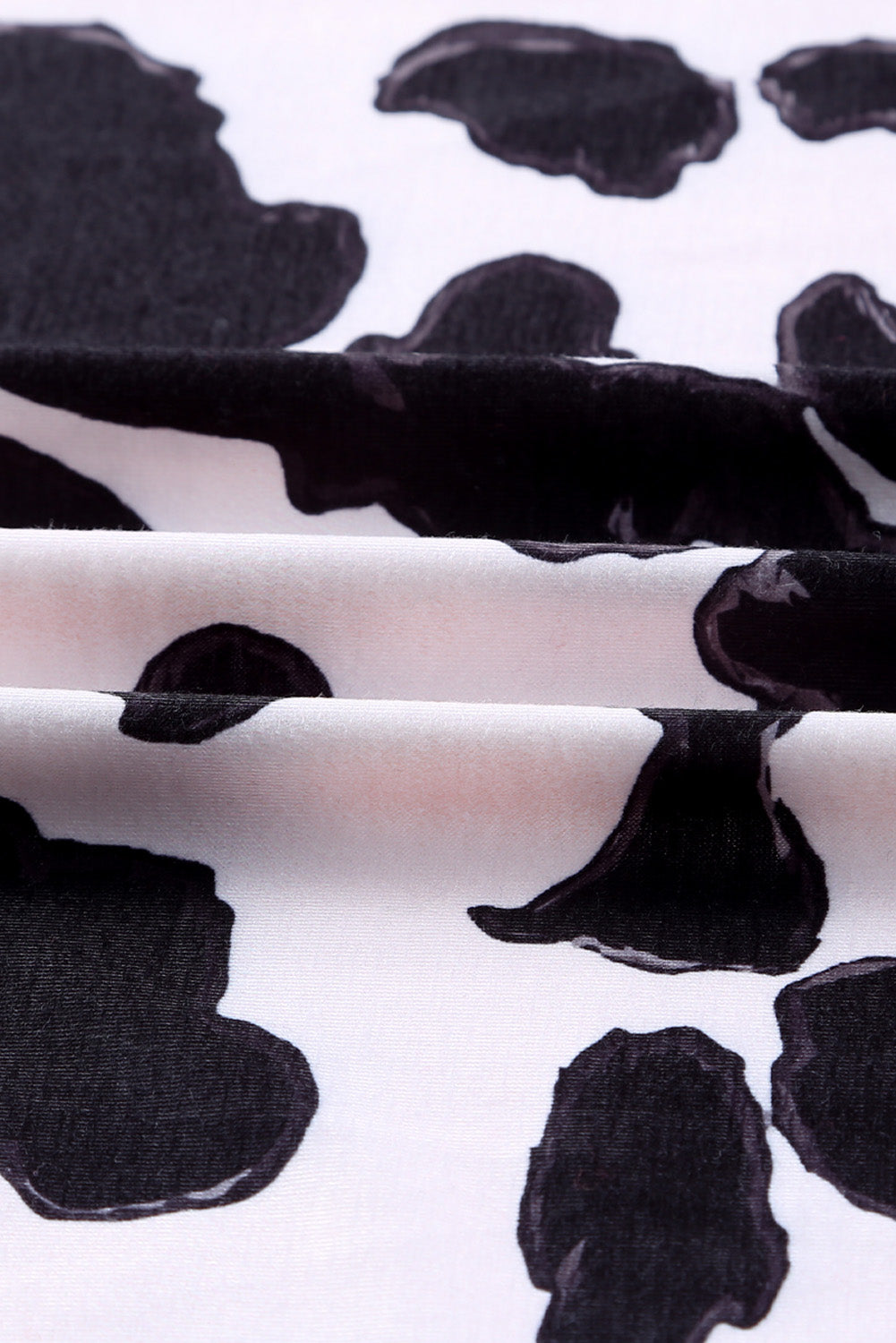 A stylish pink cardigan featuring a western cow patchwork design, open front style, perfect for casual wear.