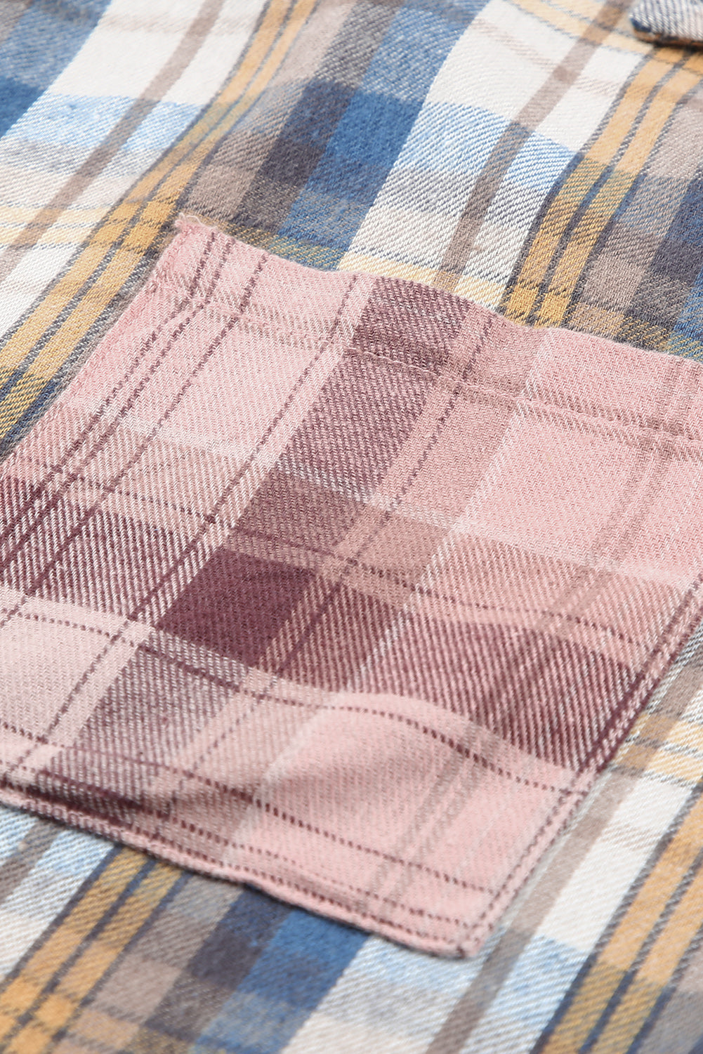 A stylish plaid pattern shirt featuring an asymmetric design, multicolor hues, and a frayed hemline, perfect for casual and vintage looks.