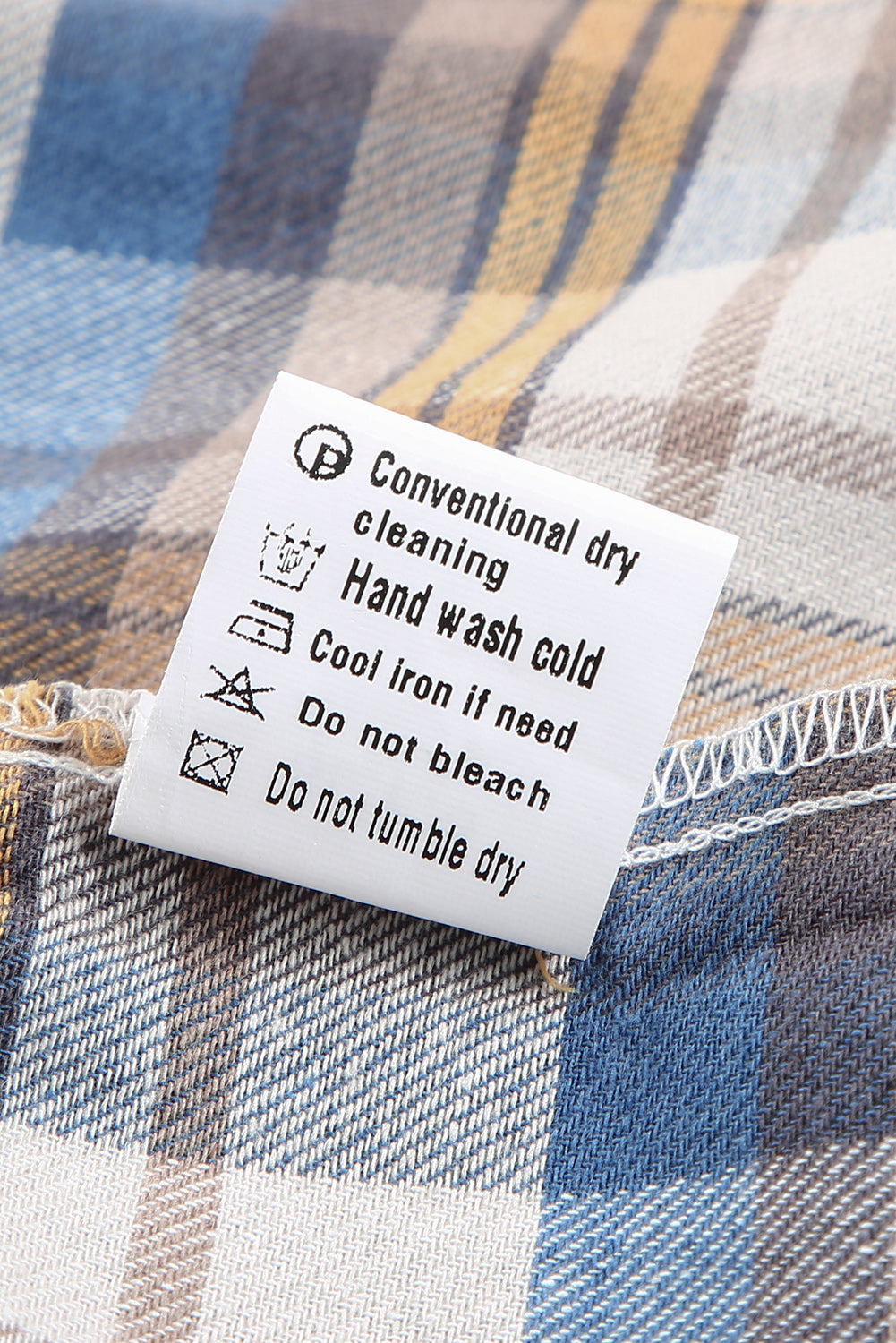 A stylish plaid pattern shirt featuring an asymmetric design, multicolor hues, and a frayed hemline, perfect for casual and vintage looks.