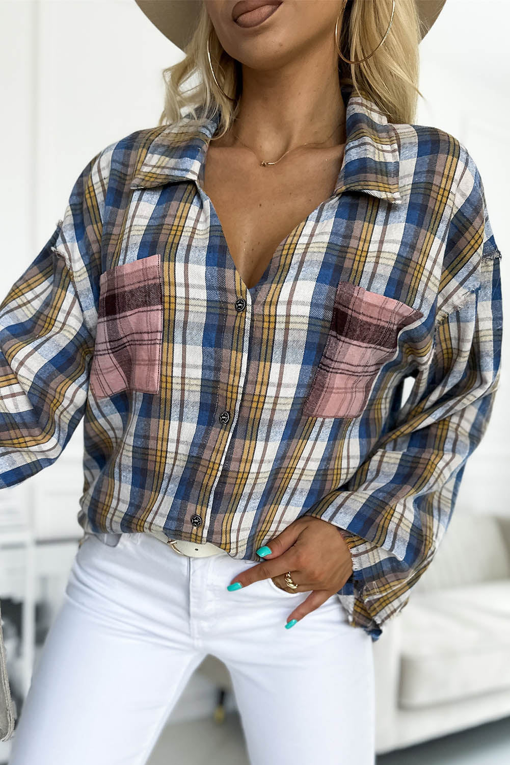 A stylish plaid pattern shirt featuring an asymmetric design, multicolor hues, and a frayed hemline, perfect for casual and vintage looks.