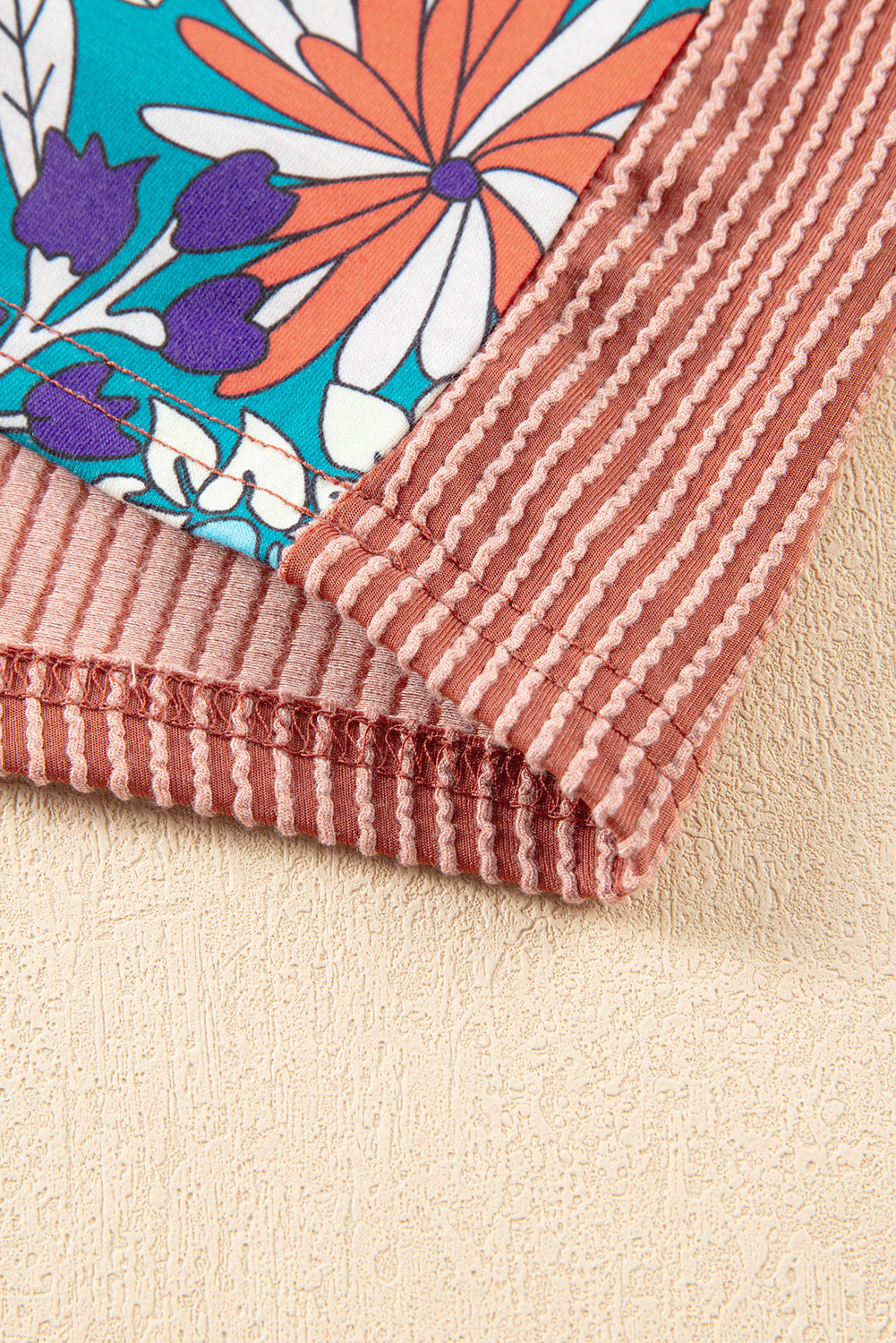 A stylish Printed Floral Contrast Colorblock Ribbed Top featuring vibrant floral patterns and ribbed fabric, perfect for casual or dressy occasions.