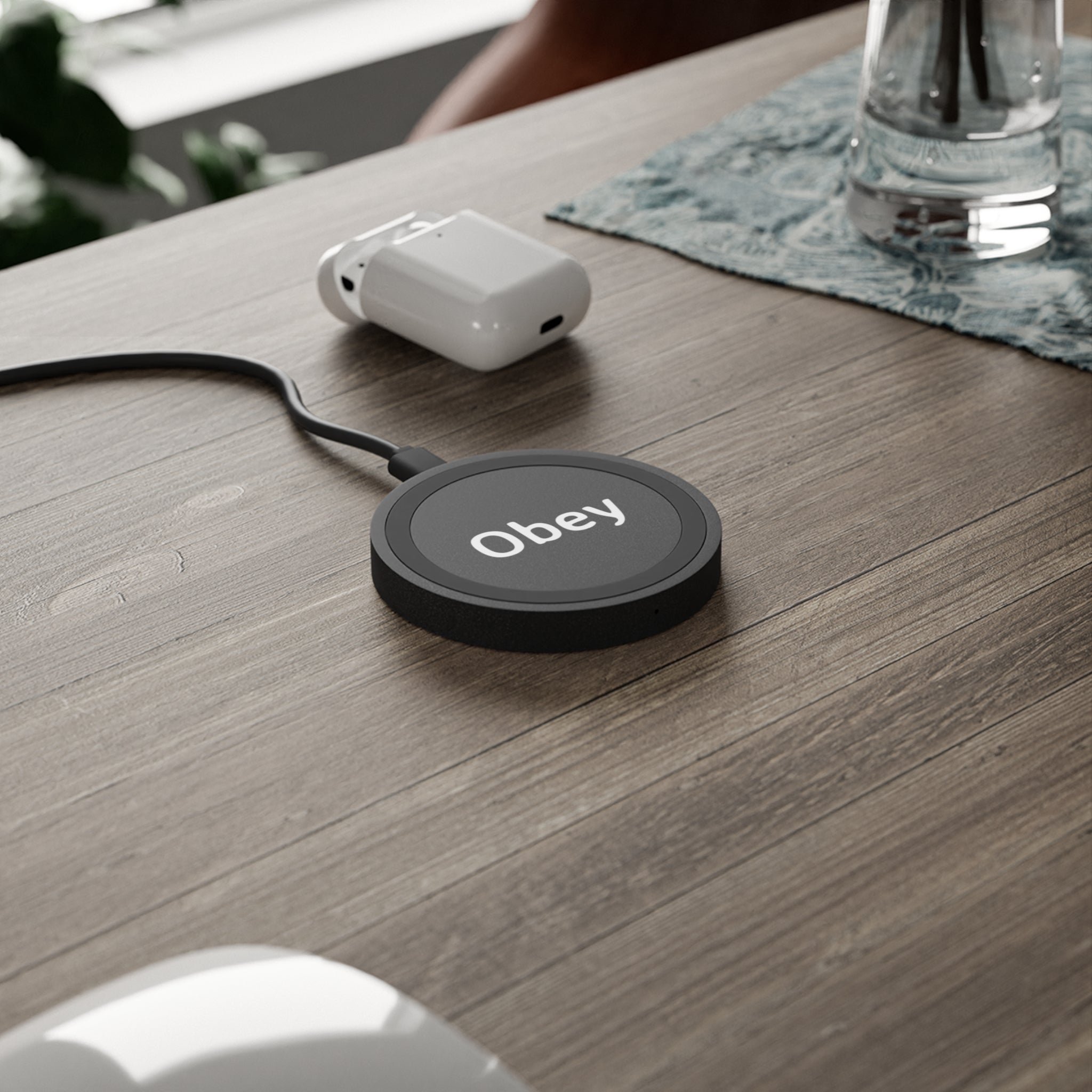 Quake Wireless Charging Pad in sleek design, made of durable double-wall plastic, charging an iPhone and an Android smartphone.
