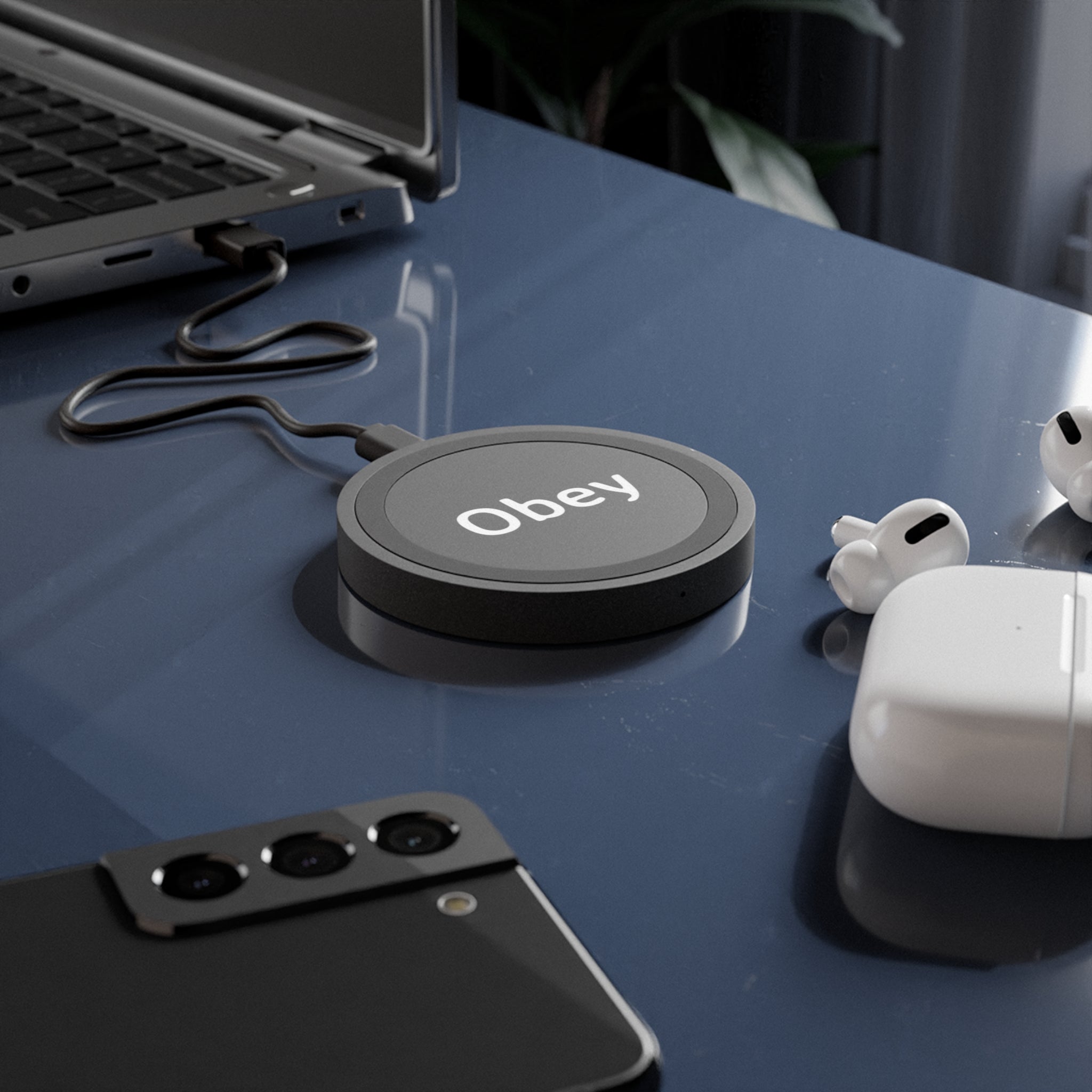 Quake Wireless Charging Pad in sleek design, made of durable double-wall plastic, charging an iPhone and an Android smartphone.