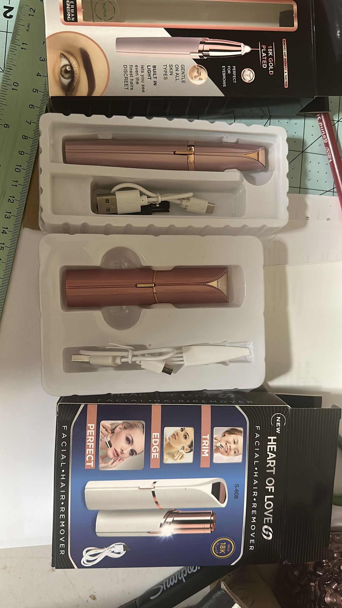 Rechargeable Facial and Eyebrow Hair Removers Set with USB cables, designed for painless hair removal on sensitive skin.