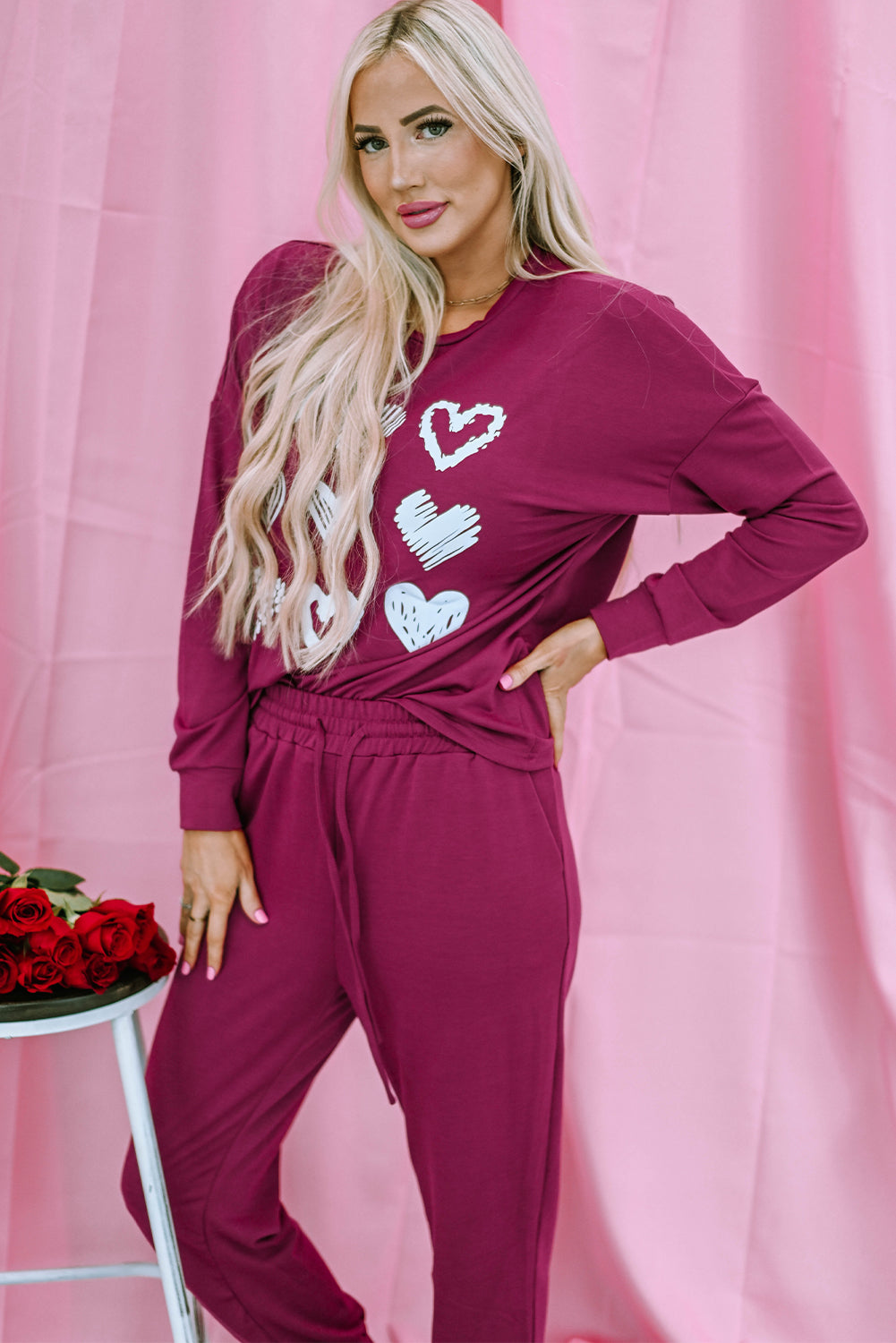 Red Heart Graphic Pullover and Drawstring Pants Lounge Set displayed on a mannequin, showcasing its cozy fabric and stylish heart design.