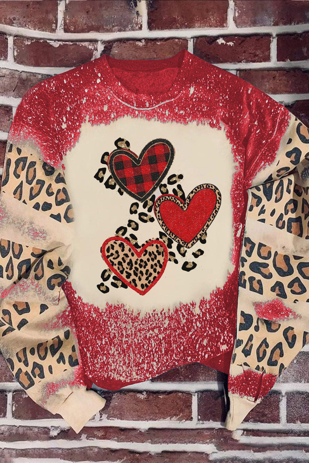 Red pullover sweatshirt featuring a heart-shaped leopard print design with a bleached effect, perfect for casual wear.
