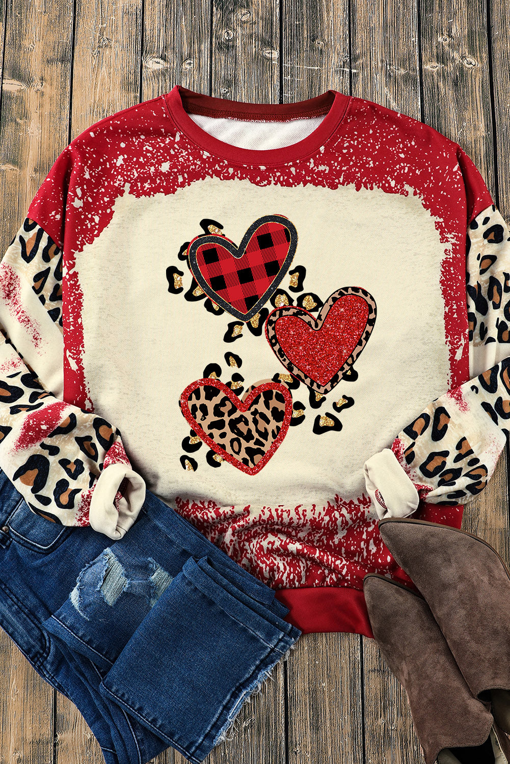 Red pullover sweatshirt featuring a heart-shaped leopard print design with a bleached effect, perfect for casual wear.