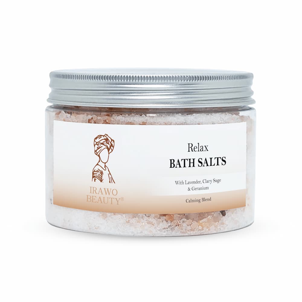 Irawo Beauty Relax Bath Salts in a clear jar, showcasing the pink and white salt crystals with a calming lavender hue, perfect for a soothing bath experience.