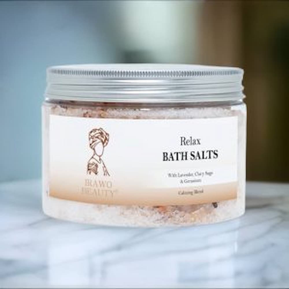 Irawo Beauty Relax Bath Salts in a clear jar, showcasing the pink and white salt crystals with a calming lavender hue, perfect for a soothing bath experience.