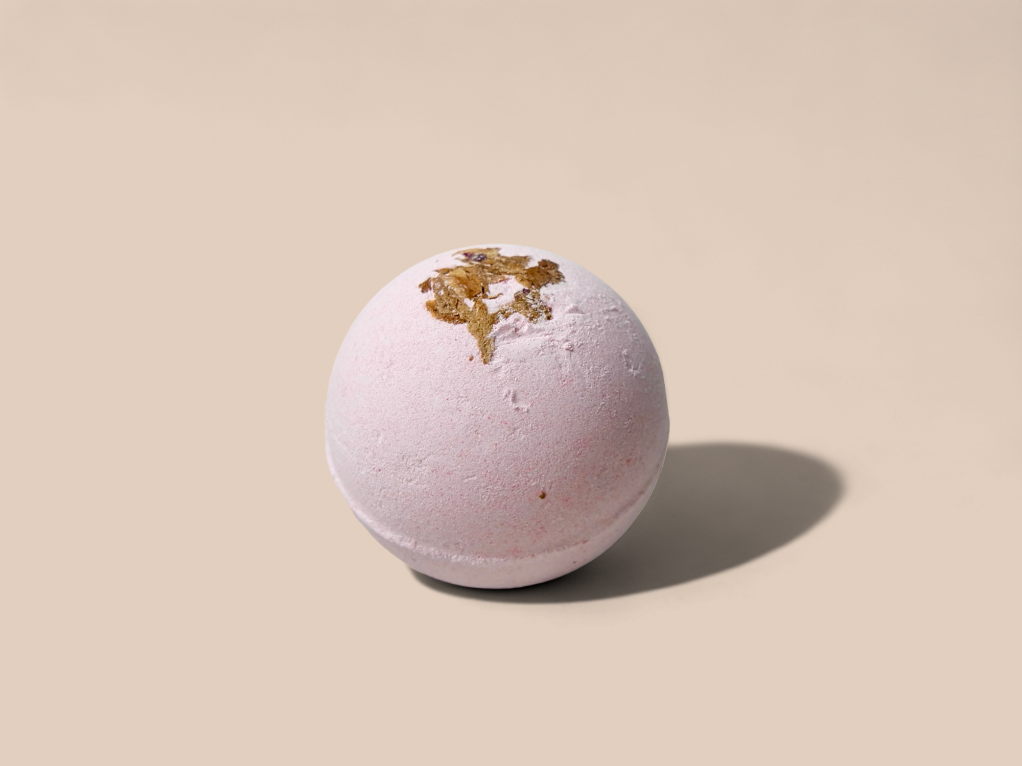 A vibrant 3oz Rose Geranium Bath Bomb, showcasing its colorful exterior and natural ingredients, perfect for a relaxing bath experience.