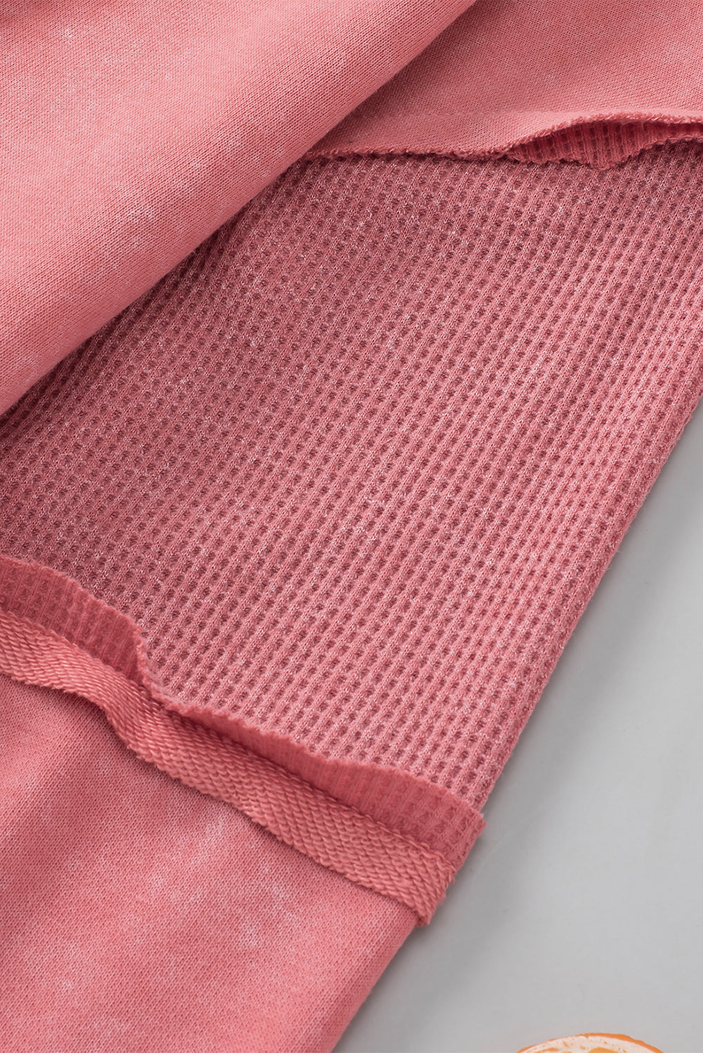 Rose Mineral Wash Patchwork Exposed Seam Sweatshirt featuring a retro design with exposed seams and a loose fit, made from fine terry fabric.