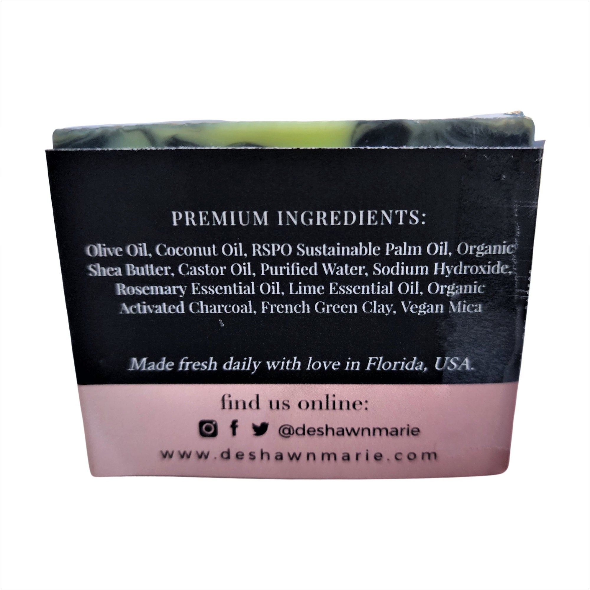 Rosemary Lime Soap bar with green clay and activated charcoal, wrapped and labeled, showcasing its natural ingredients and luxurious texture.