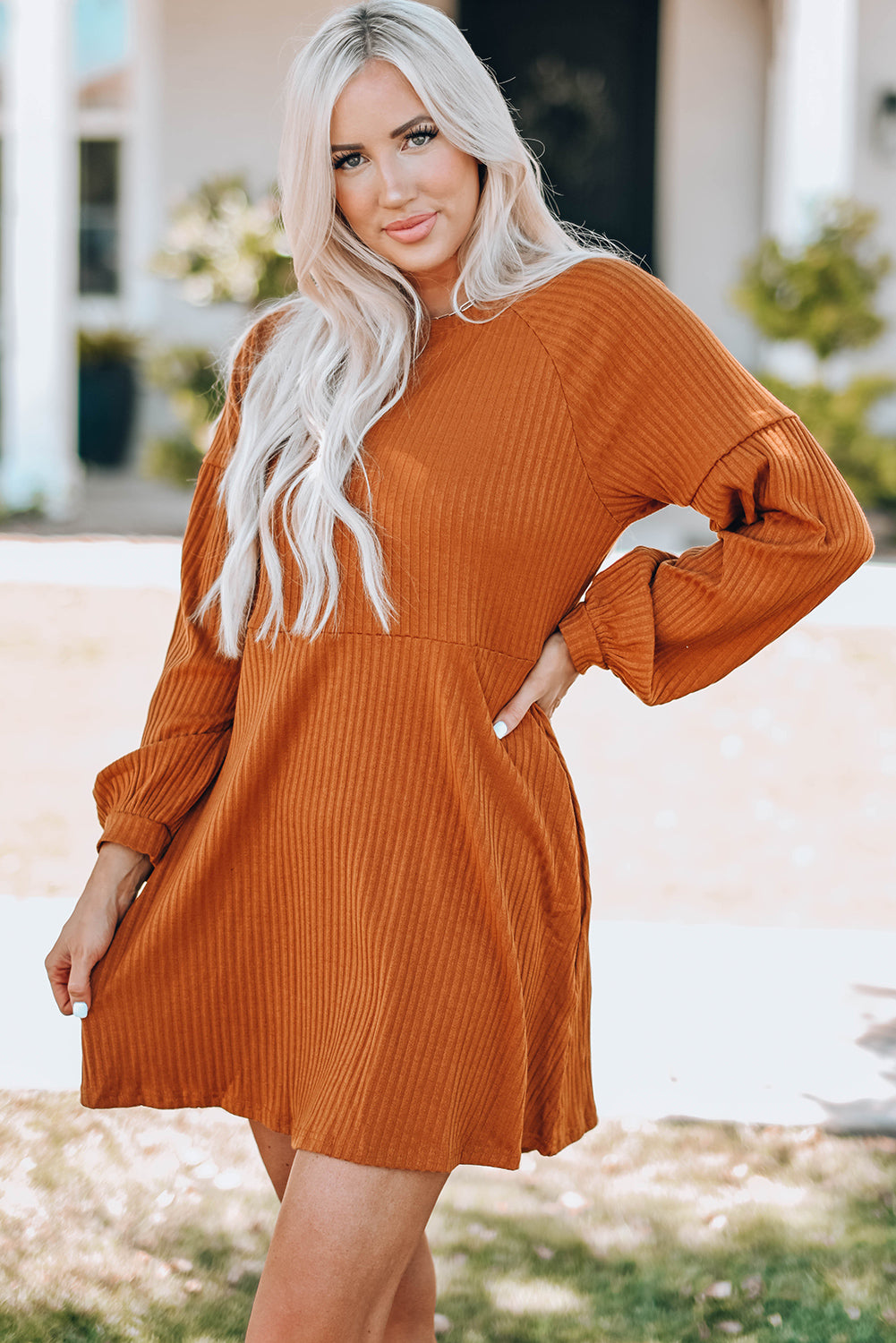 A stylish Round Neck Empire Waist Ribbed Knit Dress featuring a relaxed fit, ribbed texture, bubble sleeves, and side pockets.