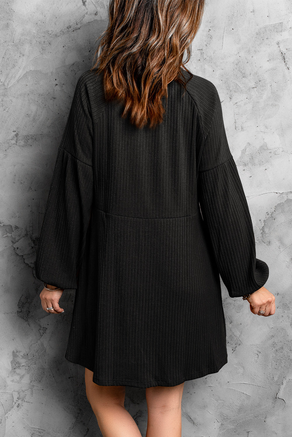 A stylish Round Neck Empire Waist Ribbed Knit Dress featuring a relaxed fit, ribbed texture, bubble sleeves, and side pockets.
