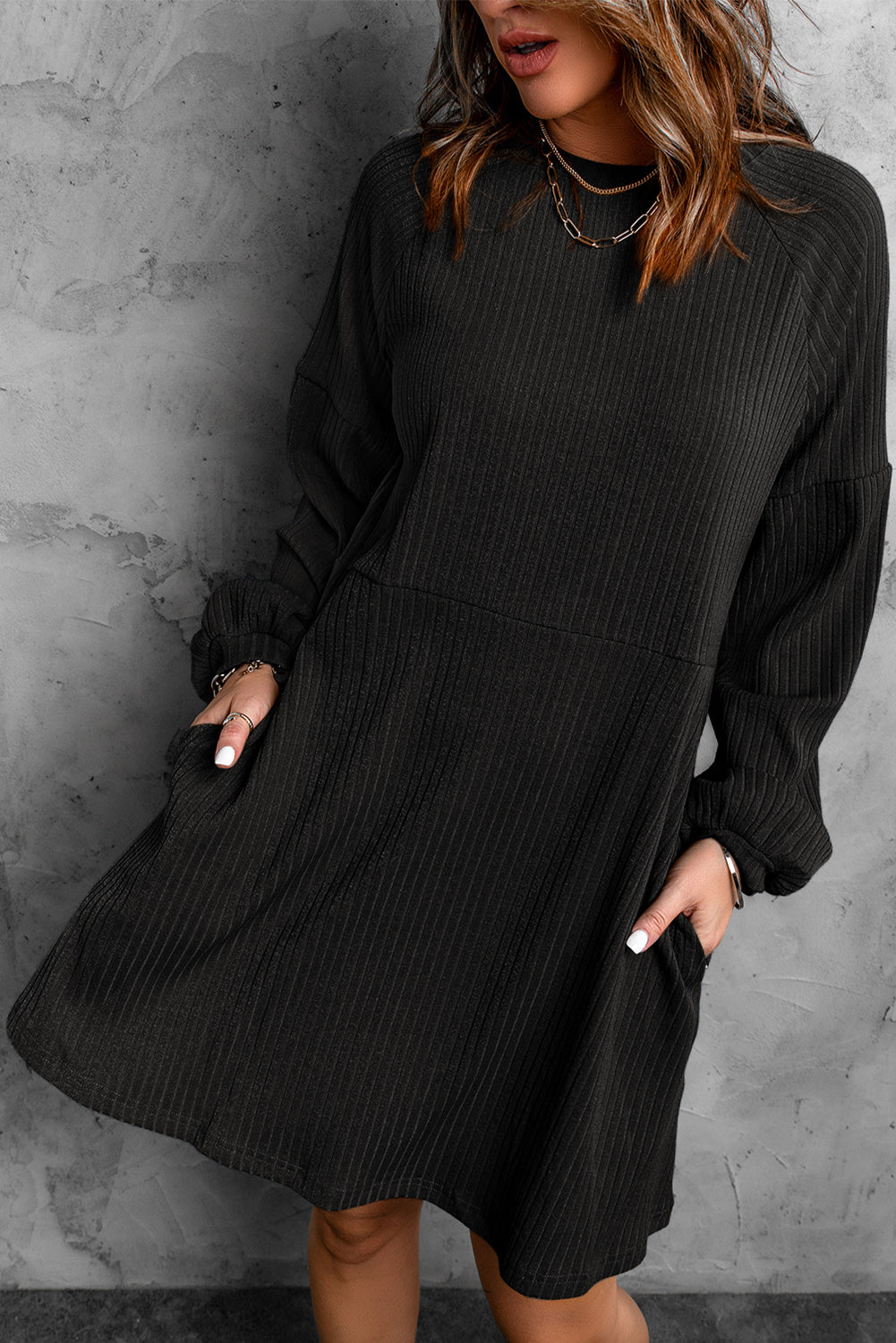 A stylish Round Neck Empire Waist Ribbed Knit Dress featuring a relaxed fit, ribbed texture, bubble sleeves, and side pockets.