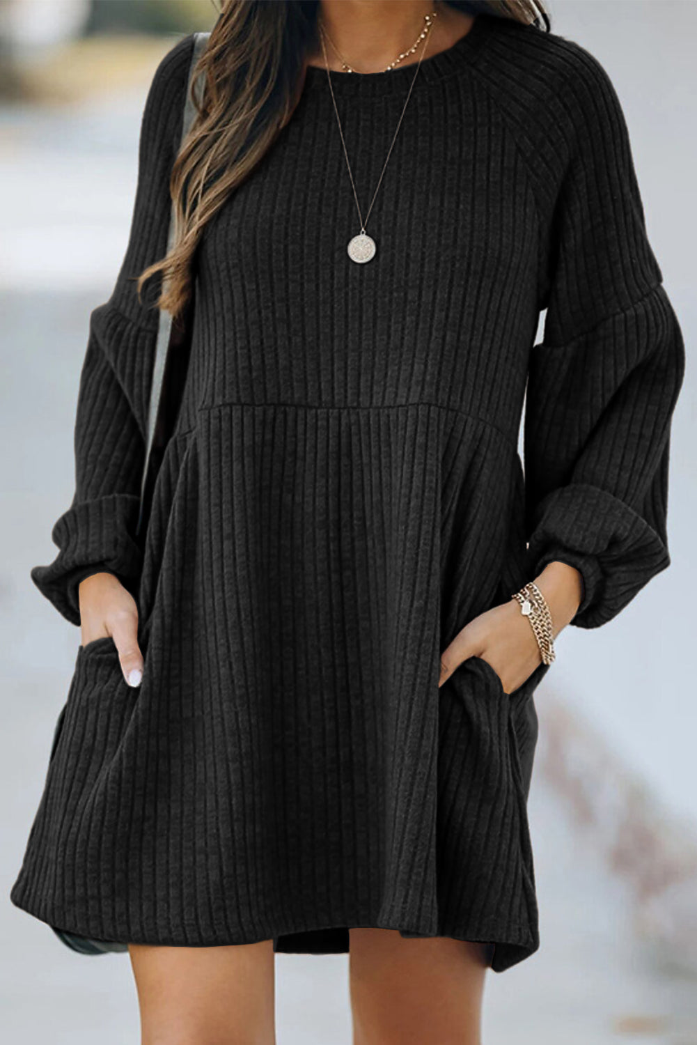 A stylish Round Neck Empire Waist Ribbed Knit Dress featuring a relaxed fit, ribbed texture, bubble sleeves, and side pockets.