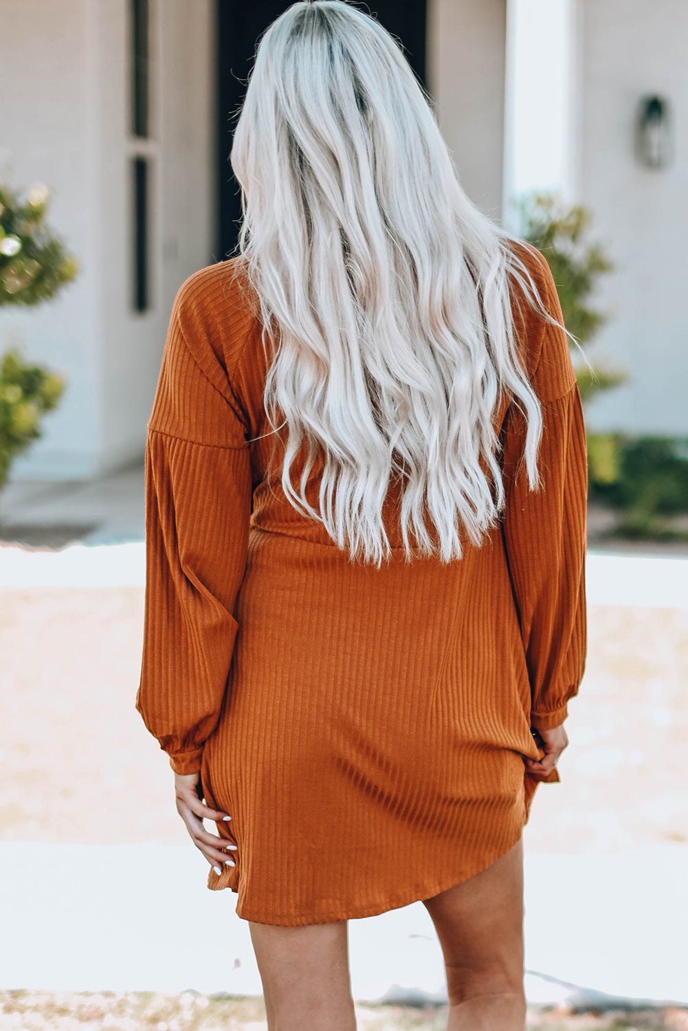 A stylish Round Neck Empire Waist Ribbed Knit Dress featuring a relaxed fit, ribbed texture, bubble sleeves, and side pockets.