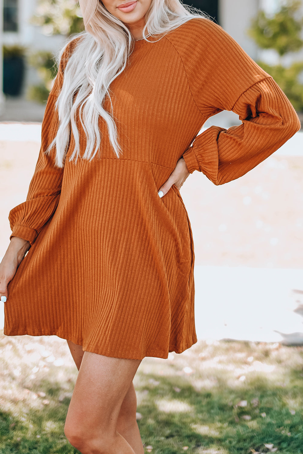 A stylish Round Neck Empire Waist Ribbed Knit Dress featuring a relaxed fit, ribbed texture, bubble sleeves, and side pockets.