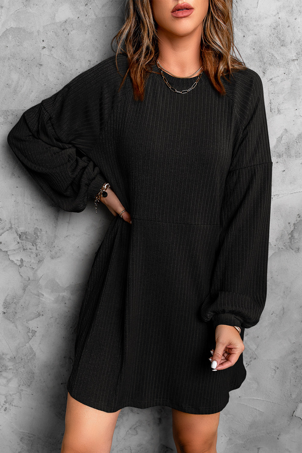 A stylish Round Neck Empire Waist Ribbed Knit Dress featuring a relaxed fit, ribbed texture, bubble sleeves, and side pockets.
