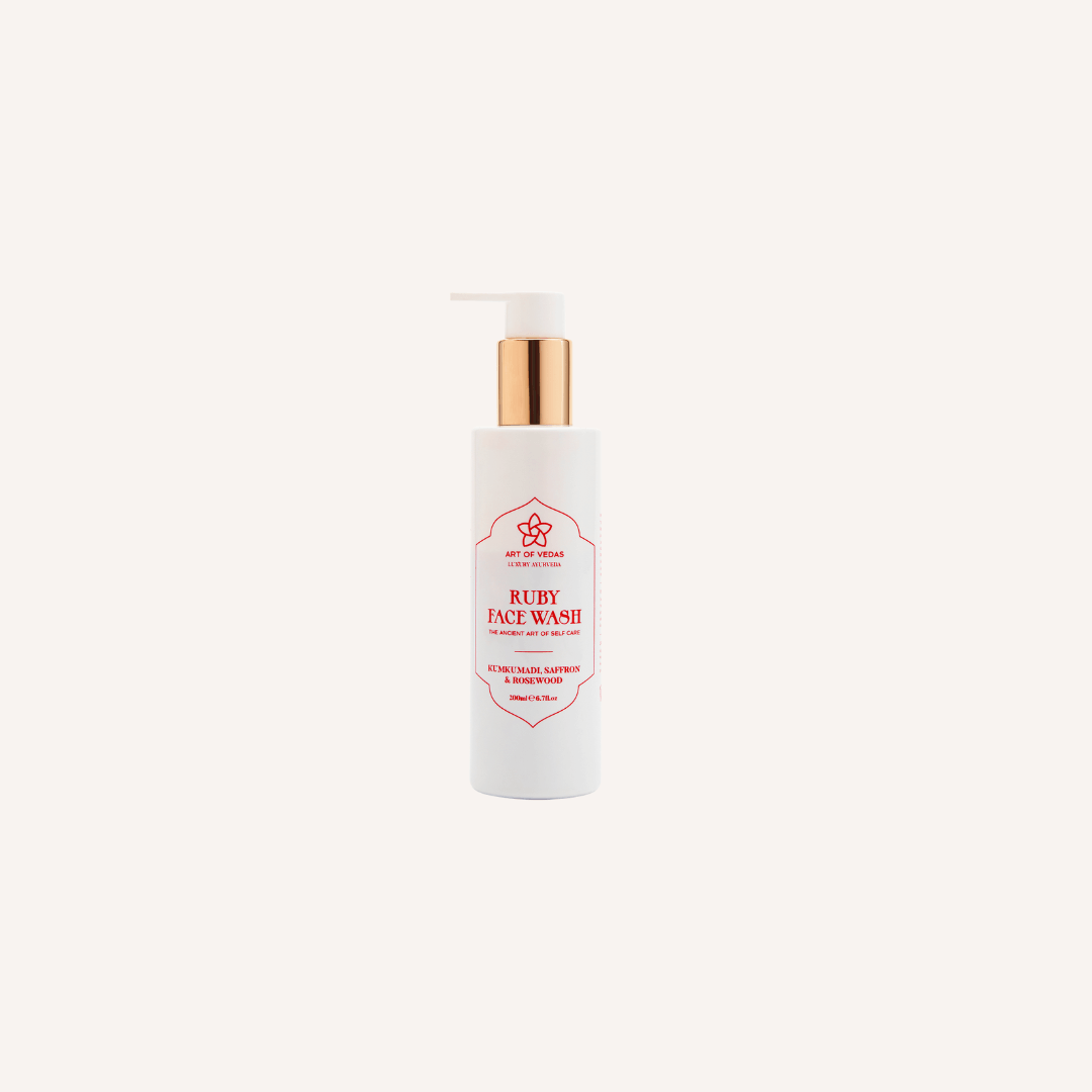 A bottle of Ruby Face Wash - Kumkumadi with a luxurious design, showcasing its Ayurvedic ingredients and vibrant packaging.