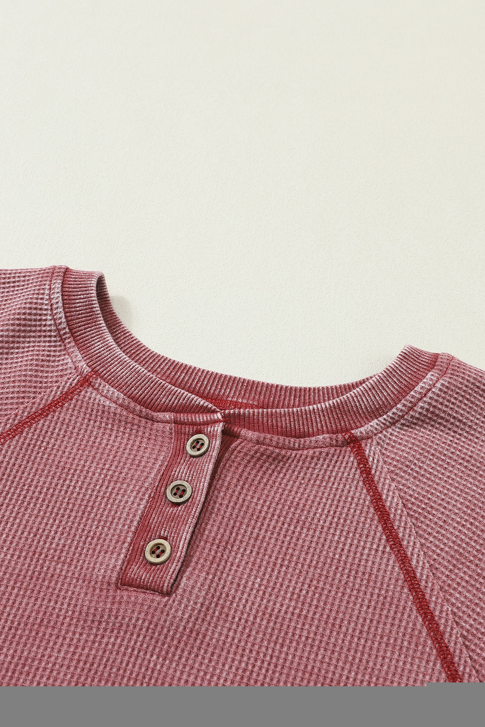 A stylish sea green waffle knit raglan sleeve Henley sweatshirt with button closure, showcasing a relaxed fit and ribbed trims.