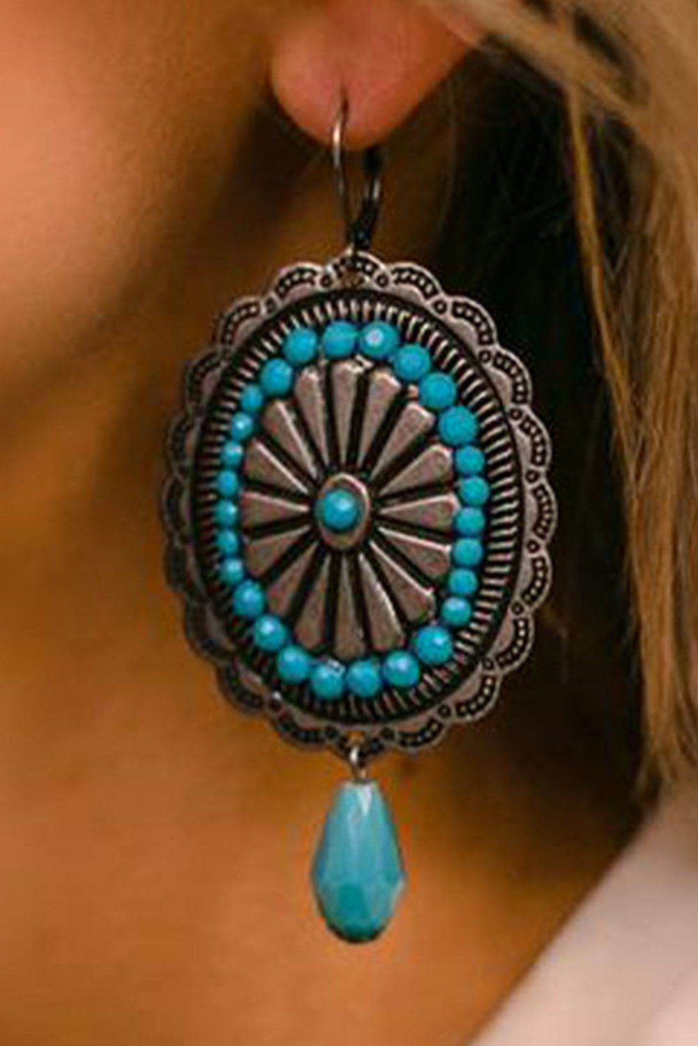 A pair of Sea Green Western Retro Turquoise Dangle Earrings featuring intricate designs and vibrant turquoise stones, perfect for stylish accessorizing.