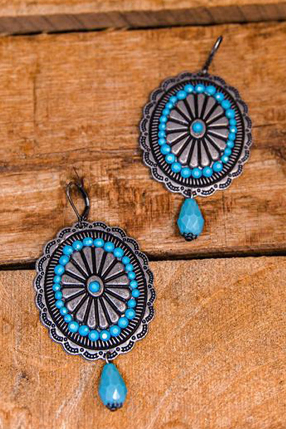 A pair of Sea Green Western Retro Turquoise Dangle Earrings featuring intricate designs and vibrant turquoise stones, perfect for stylish accessorizing.