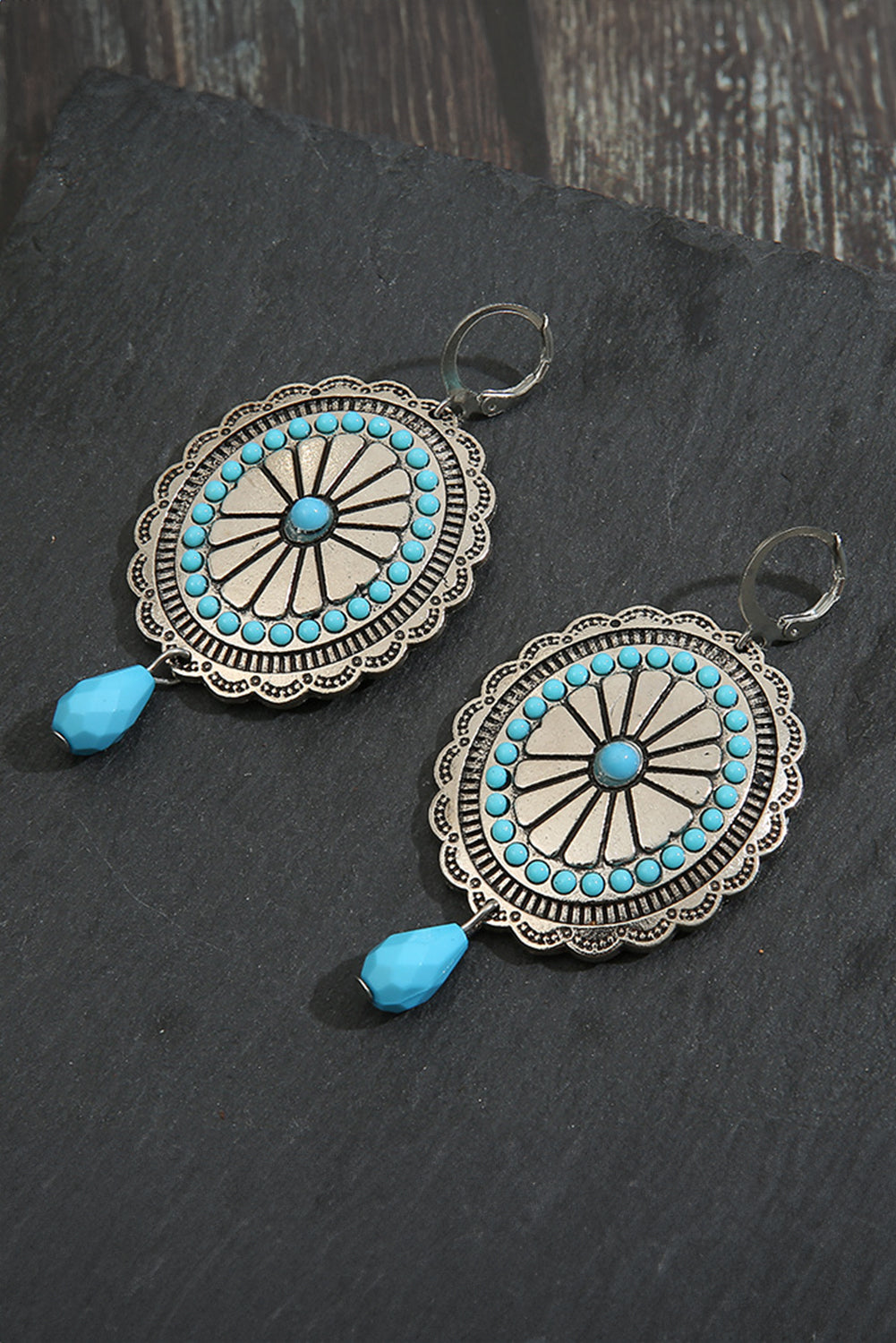 A pair of Sea Green Western Retro Turquoise Dangle Earrings featuring intricate designs and vibrant turquoise stones, perfect for stylish accessorizing.