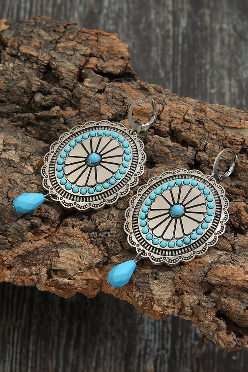 A pair of Sea Green Western Retro Turquoise Dangle Earrings featuring intricate designs and vibrant turquoise stones, perfect for stylish accessorizing.