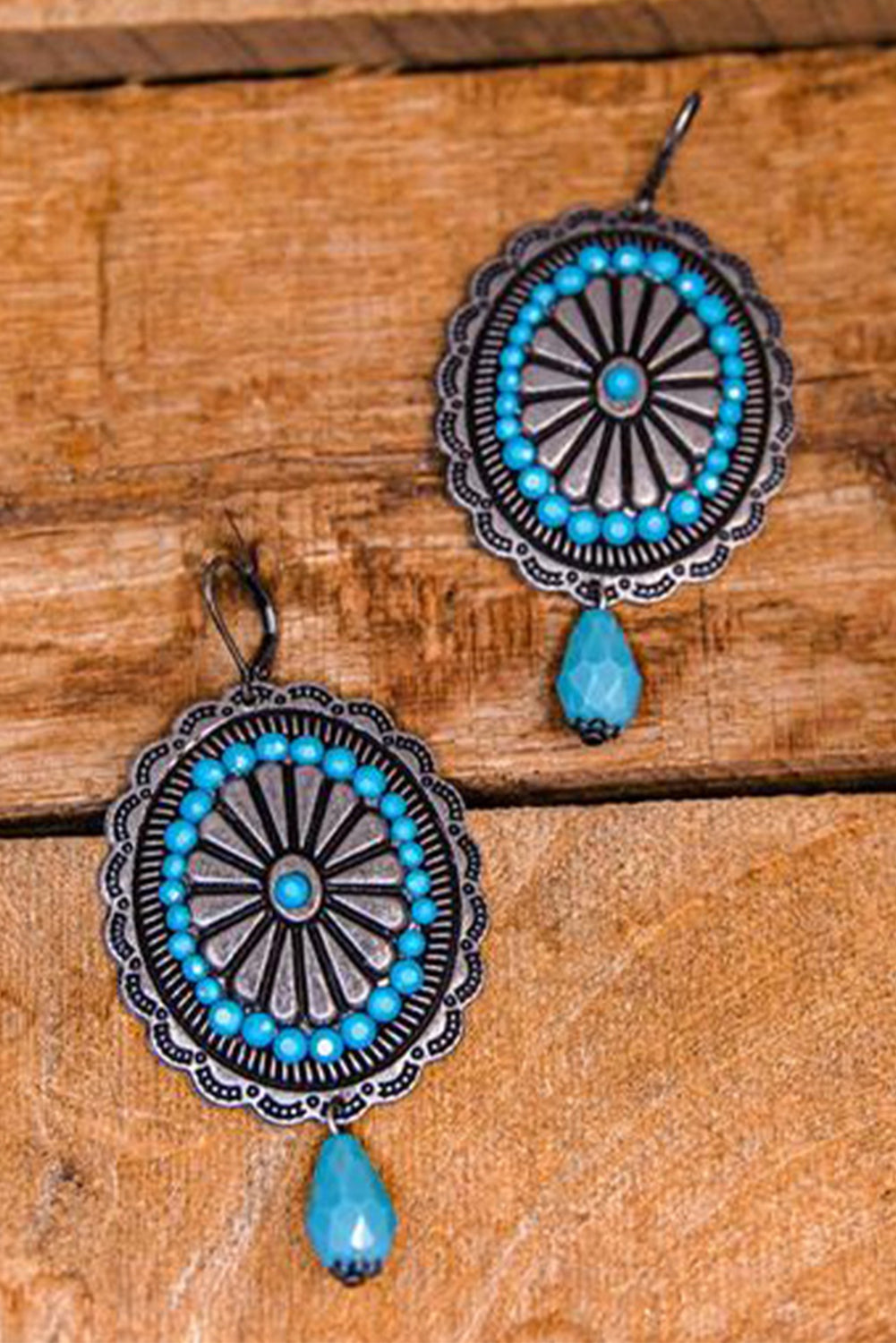 A pair of Sea Green Western Retro Turquoise Dangle Earrings featuring intricate designs and vibrant turquoise stones, perfect for stylish accessorizing.