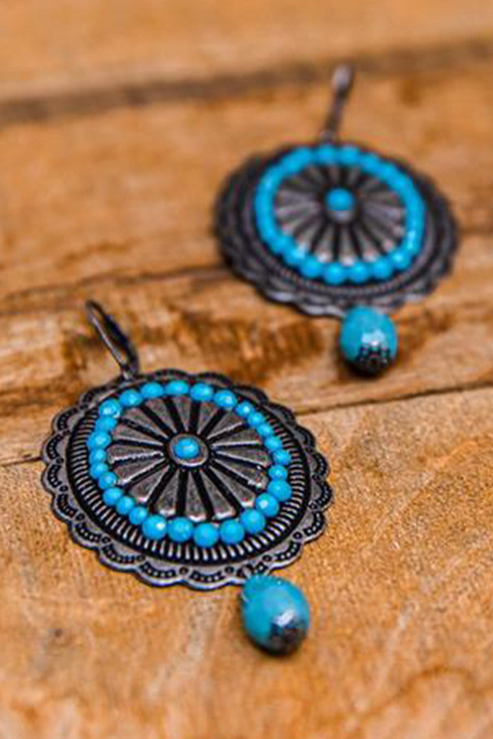 A pair of Sea Green Western Retro Turquoise Dangle Earrings featuring intricate designs and vibrant turquoise stones, perfect for stylish accessorizing.