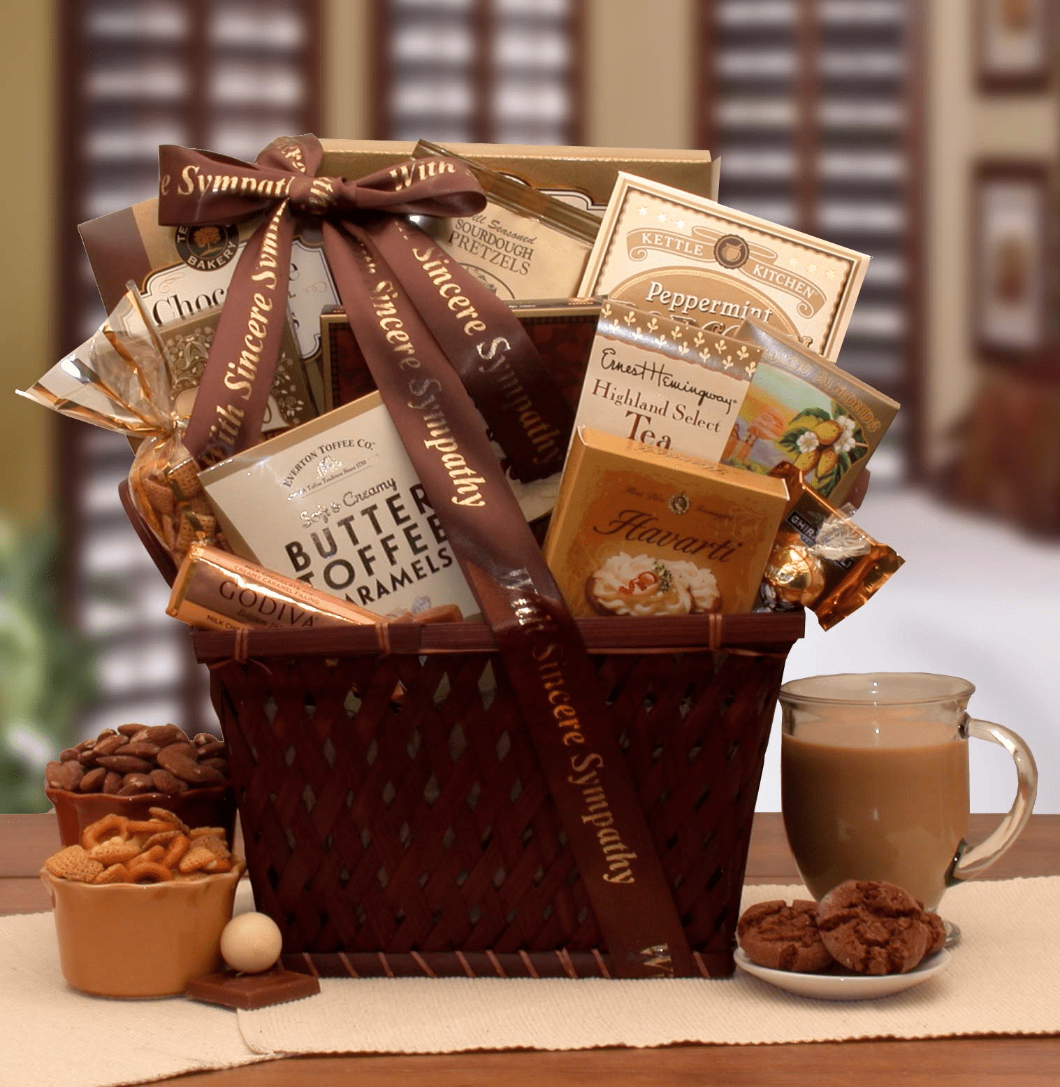 Sending Our Prayers Sympathy Gift Basket filled with gourmet snacks and treats, beautifully wrapped with a sympathy sash and bow.