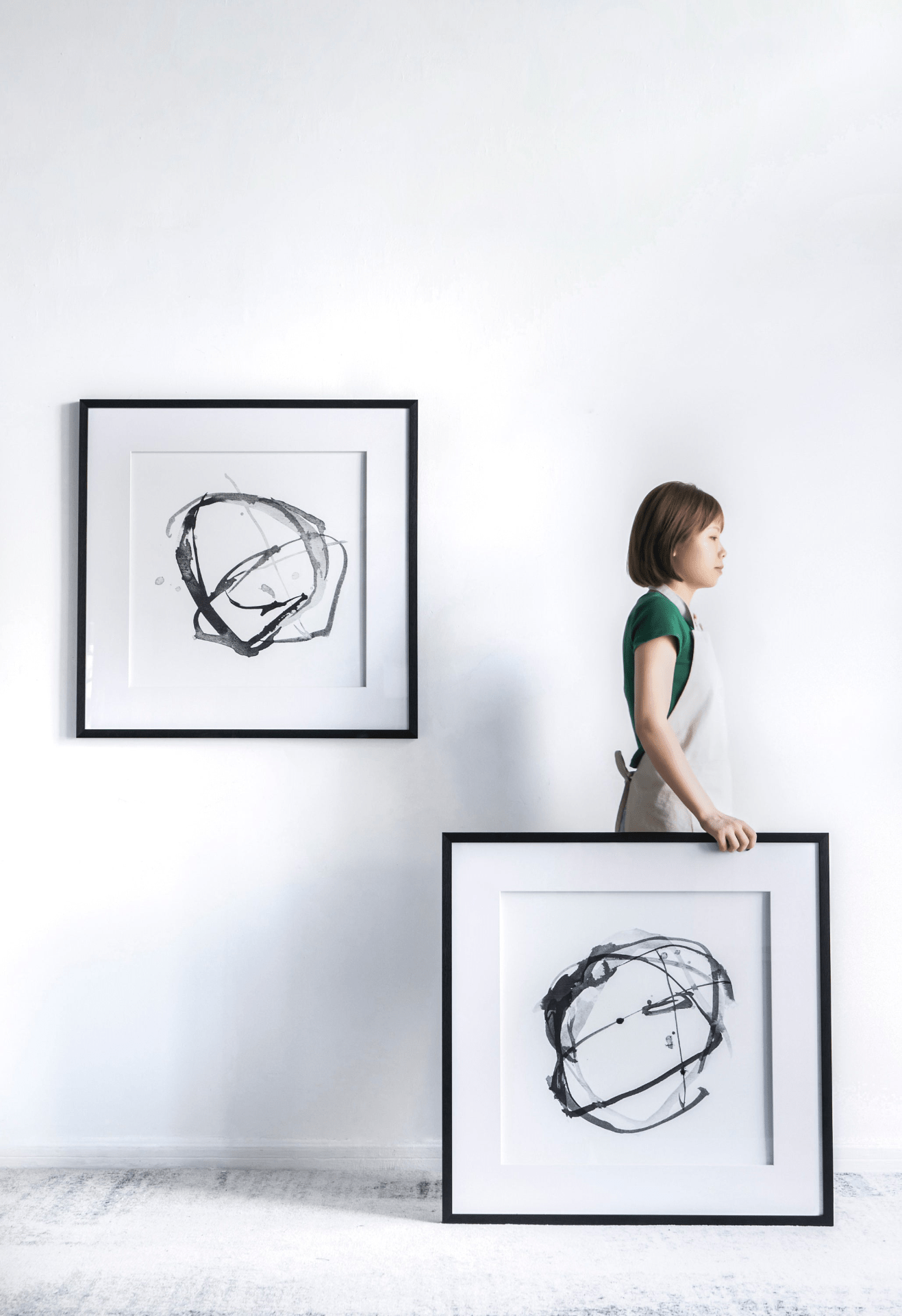 Set of 2 modern abstract wall art prints framed in black, featuring contrasting shades of gray and white, measuring 31.5 inches square.