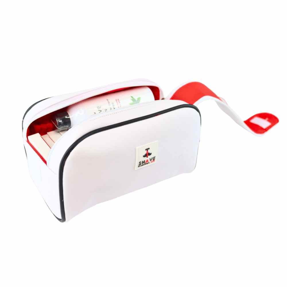 Shave Travel Kit containing a cartridge razor handle, shave cream, aftershave, and face wash in a compact toiletry bag.