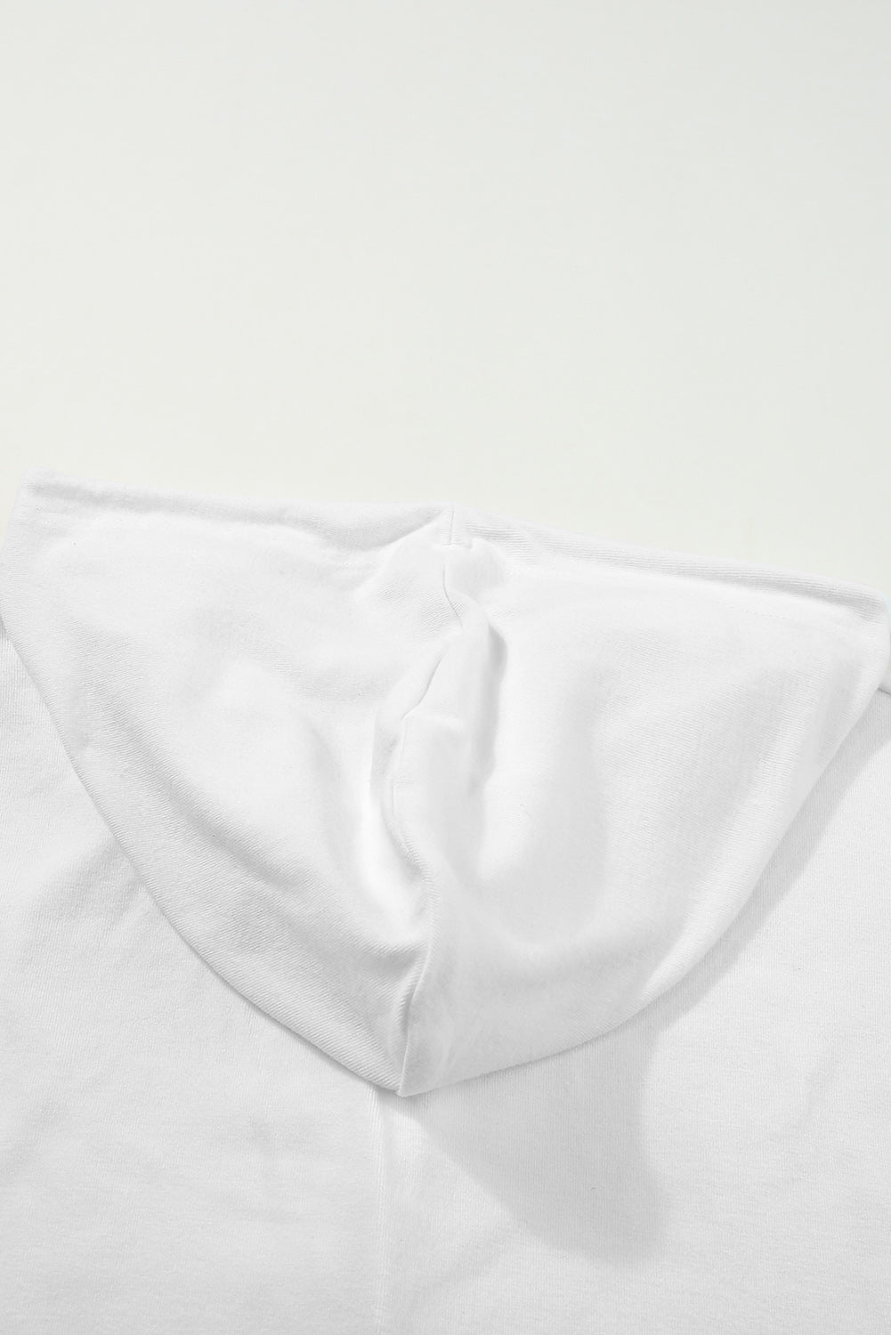 Sky Blue Buttoned High and Low Hem Hoodie with drawstring hood and tortoiseshell buttons, showcasing a relaxed fit and side slits.