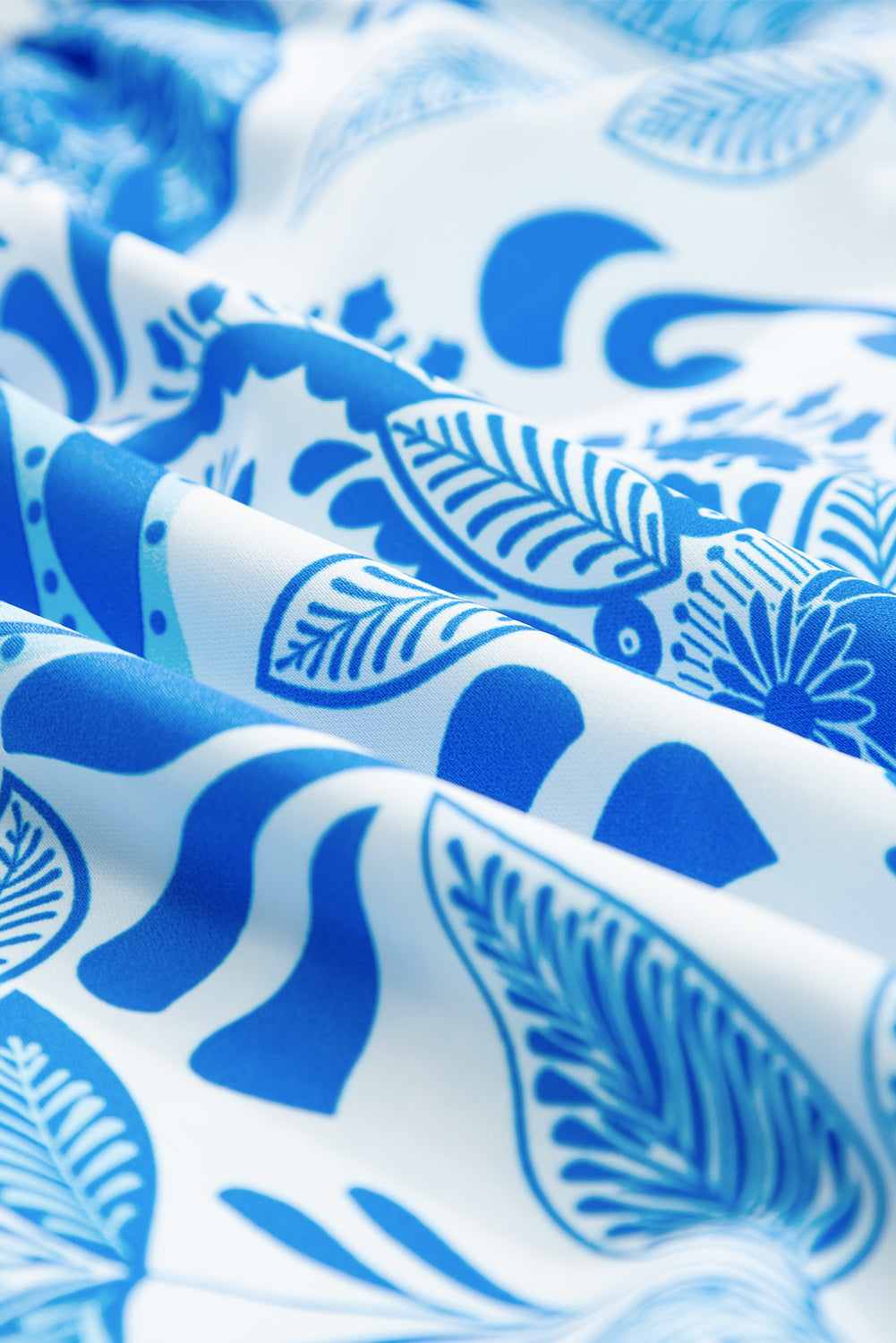 Sky blue mini dress with retro floral print, featuring a drawstring waist and ruffled hem, perfect for casual outings.