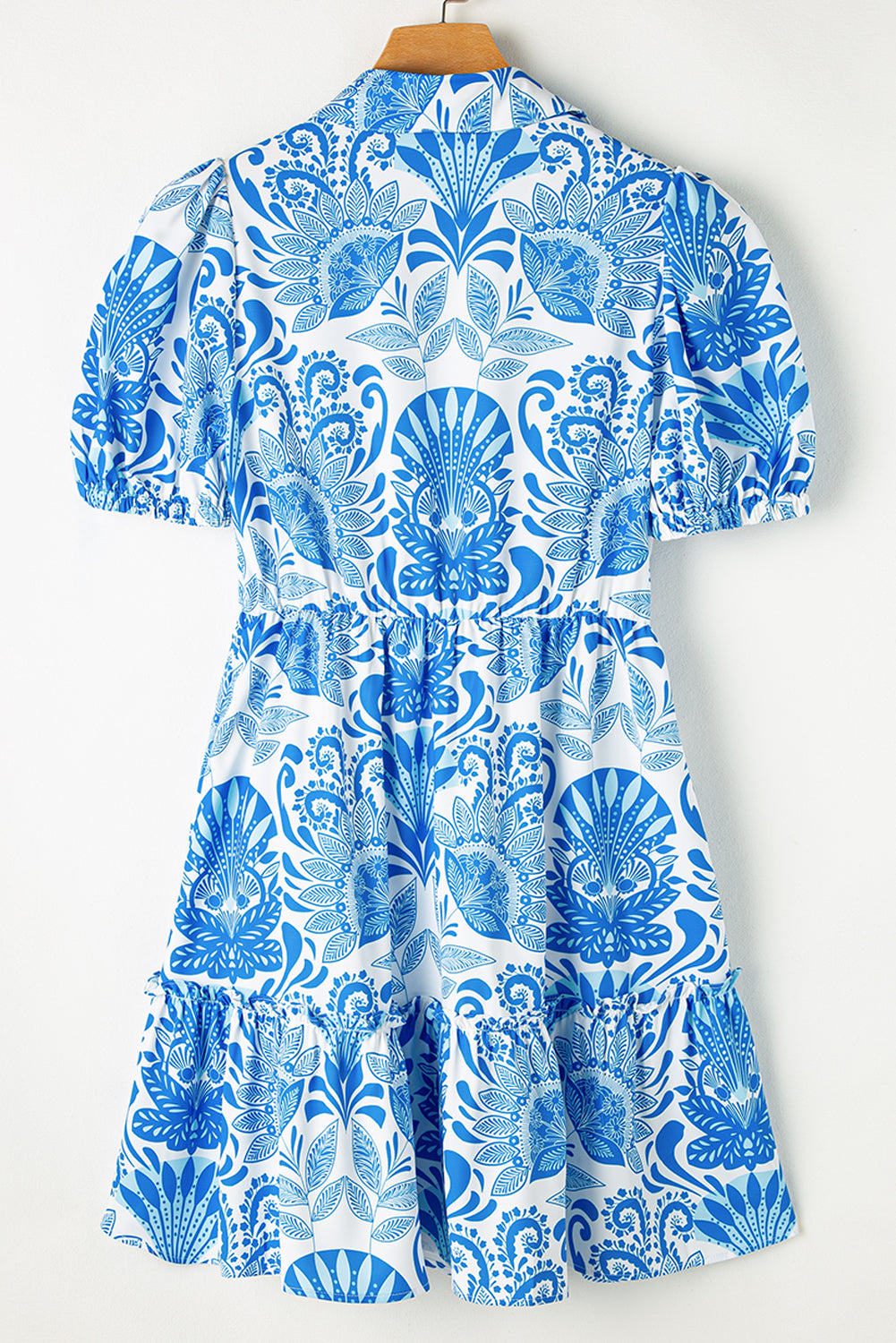 Sky blue mini dress with retro floral print, featuring a drawstring waist and ruffled hem, perfect for casual outings.